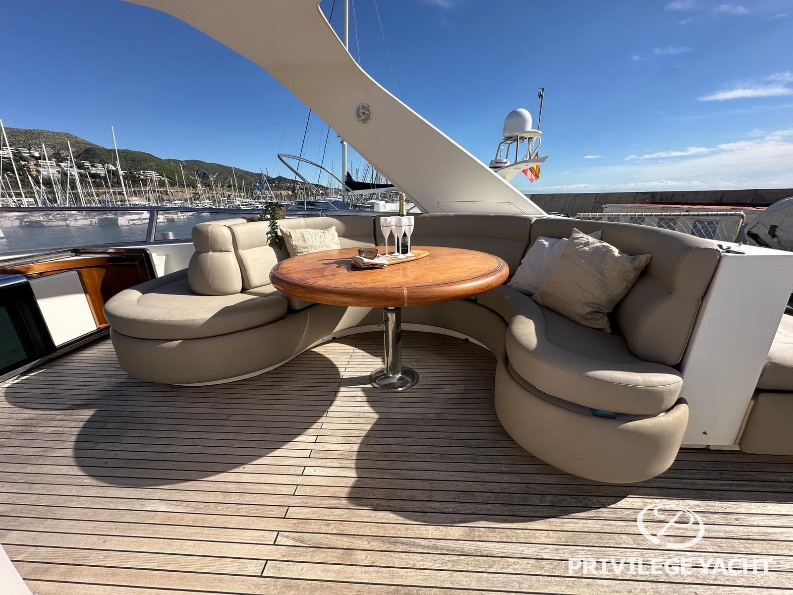 Luxurious Elegance 76 yacht deck with round table and plush seating, 2003 model.