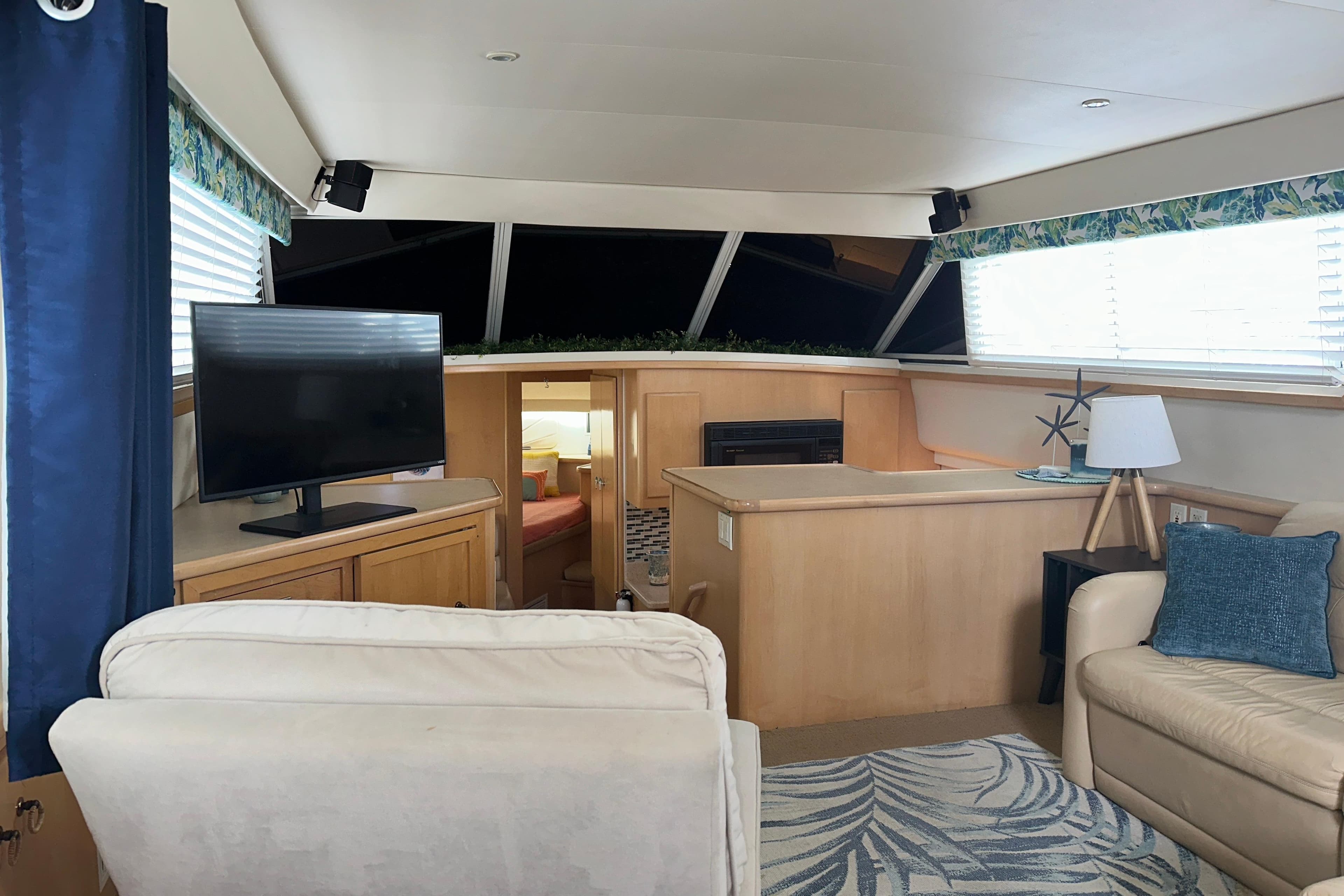 Interior of 1998 Carver 445 Aft Cabin Motor Yacht with cozy seating and TV.