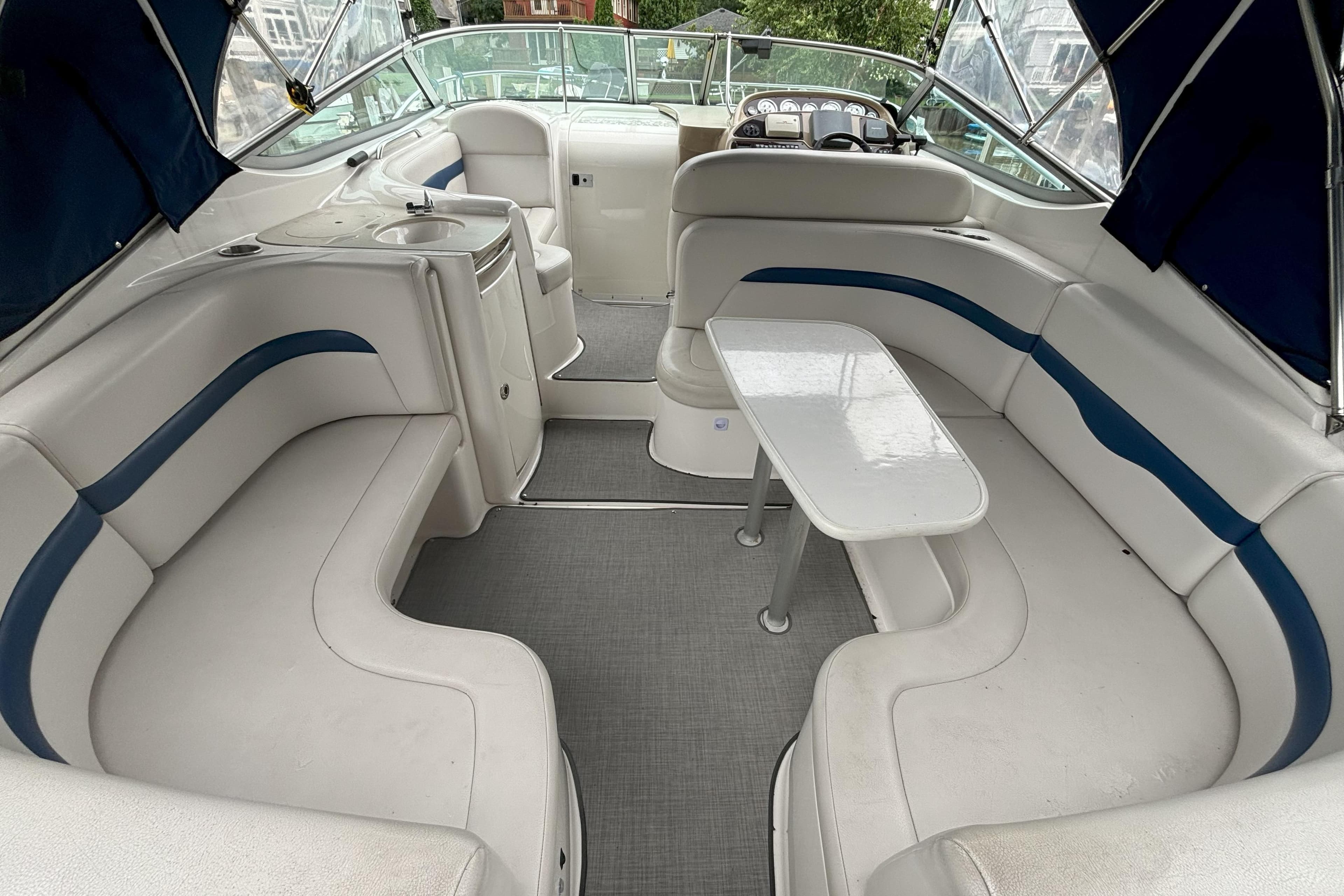 2003 Chaparral 310 Signature boat interior with white seating and table.