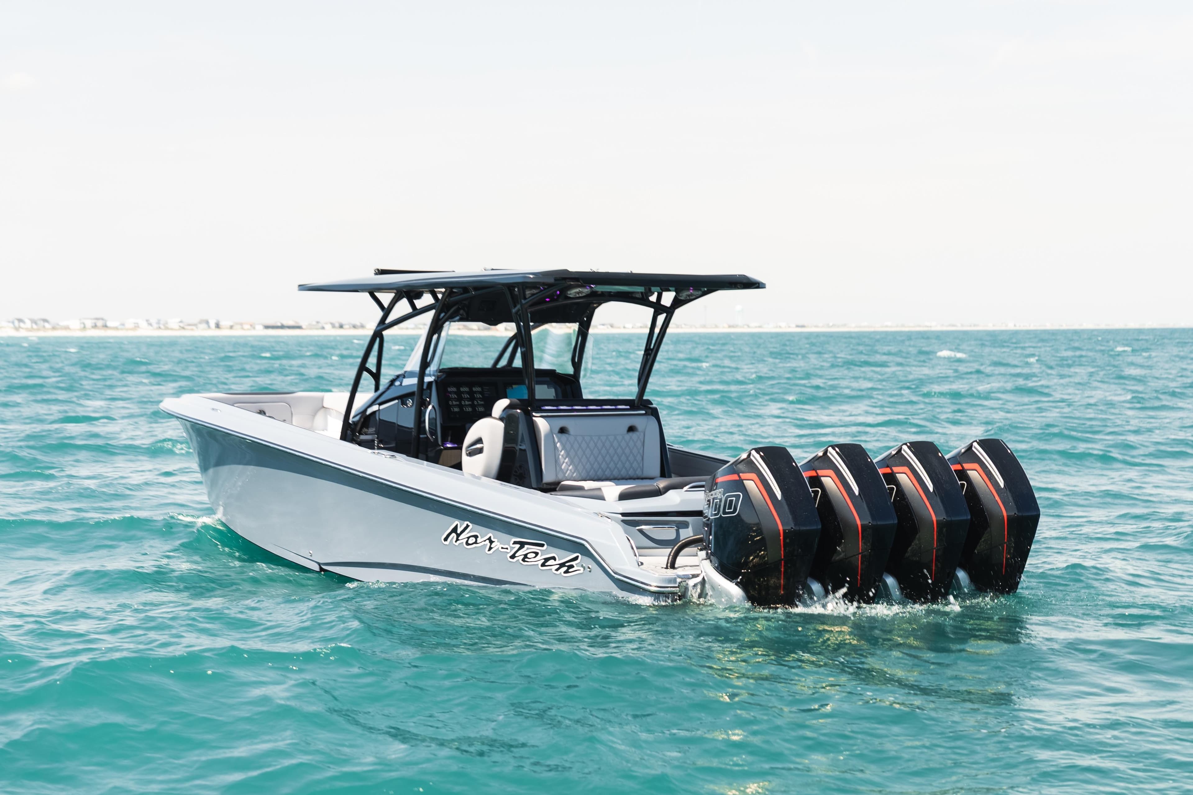 2025 Nor-Tech 340 Sport Center Console boat on open water with four engines.