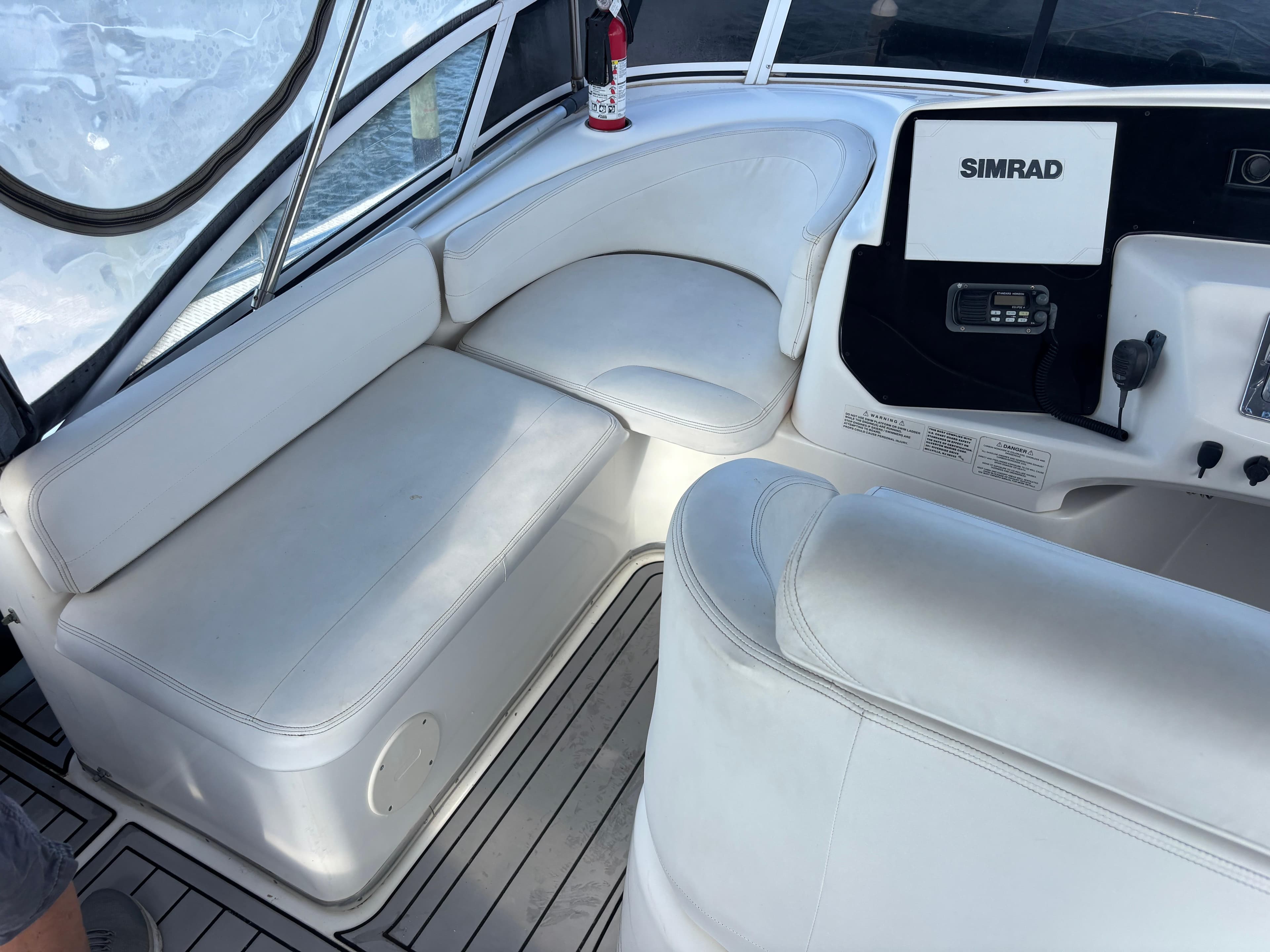 2001 Silverton 410 Sport Bridge interior with white seating and Simrad navigation system.