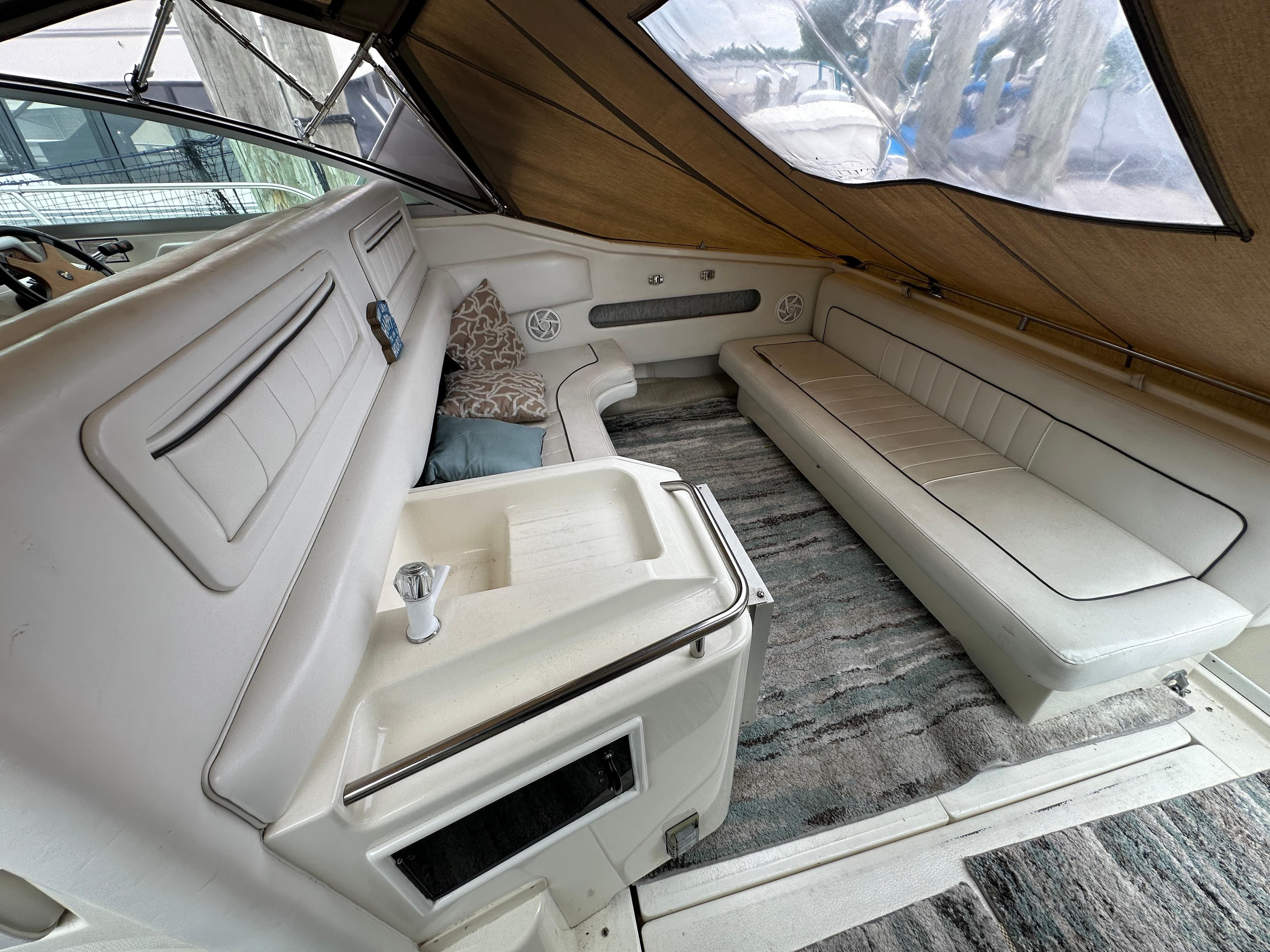 Interior of 1994 Sea Ray 370 Sundancer with white seating and carpeted floor.