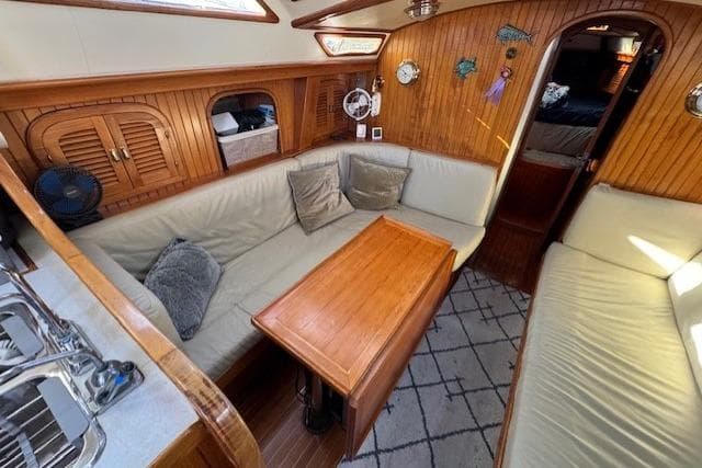 Cozy interior of 1986 Fairweather Mariner 39 sailboat with wooden accents and seating area.