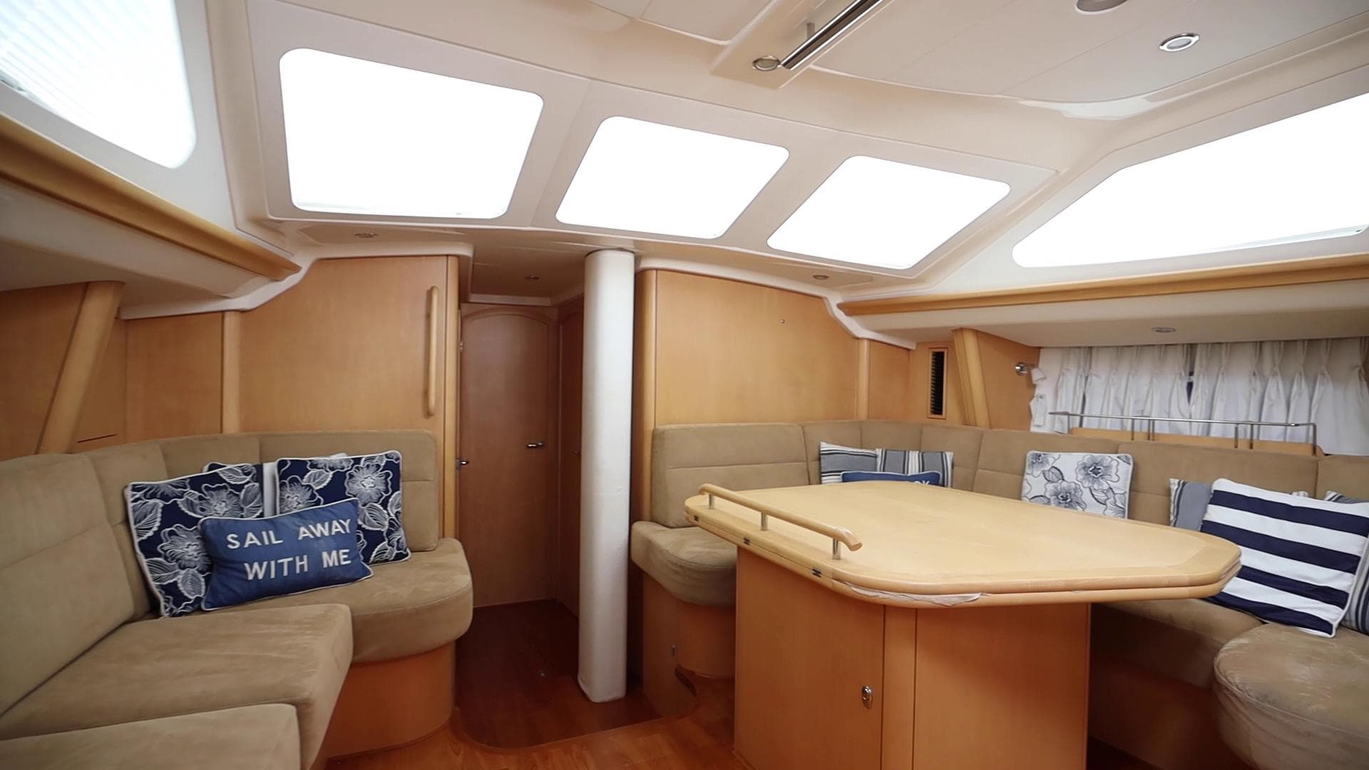 Luxurious interior of 2010 Oyster 54 yacht with cozy seating and nautical decor.