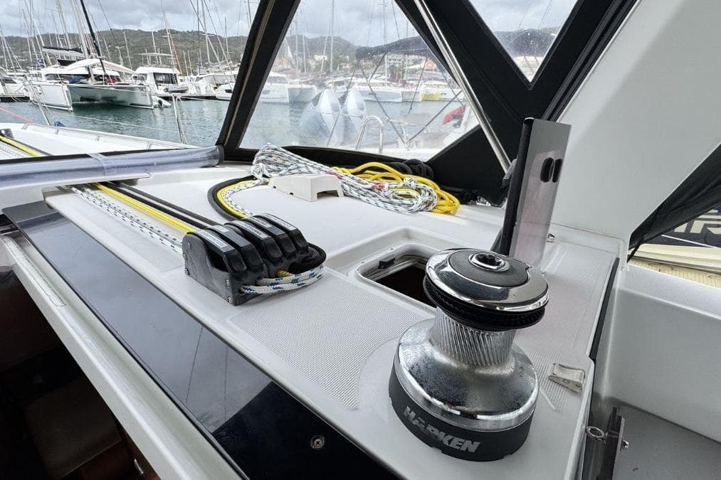 Deck of 2012 Beneteau Oceanis 41 sailboat with winch and ropes in marina.