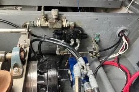 Engine compartment of a 1996 Premium 28 Parasail boat with hydraulic components.