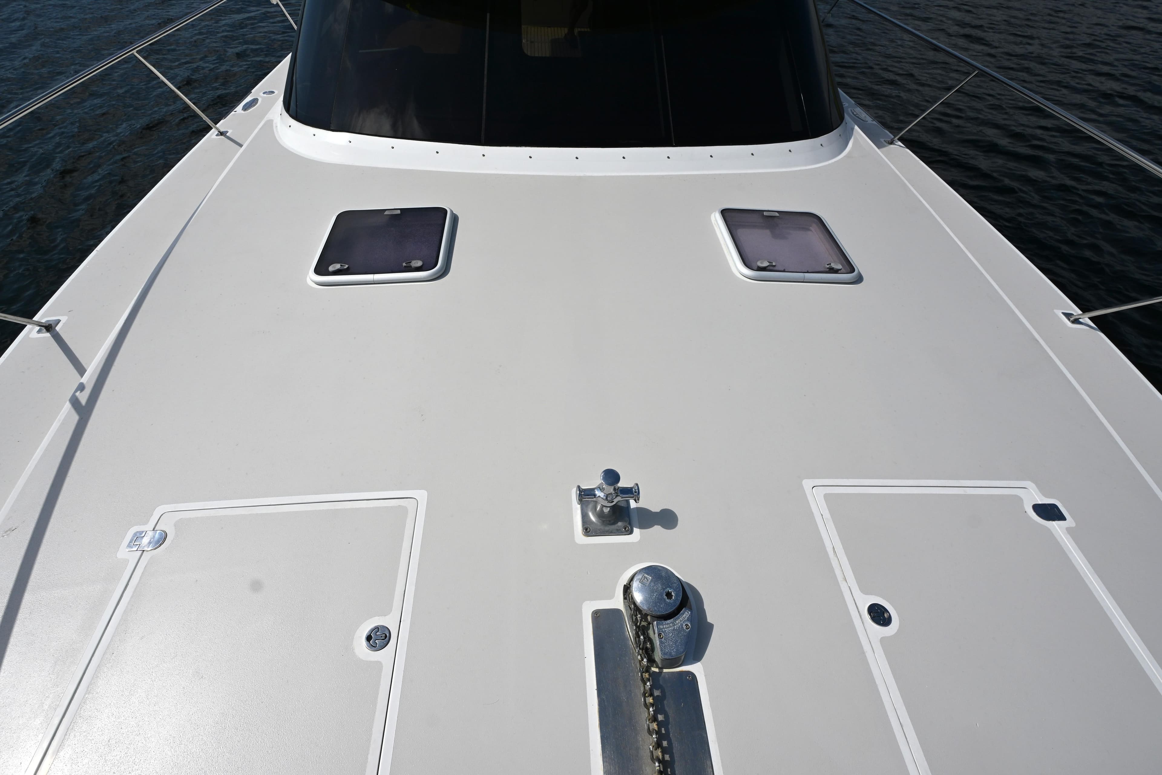Deck view of 2002 Roger Hill Power Cat 41.4, featuring hatches and anchor chain.