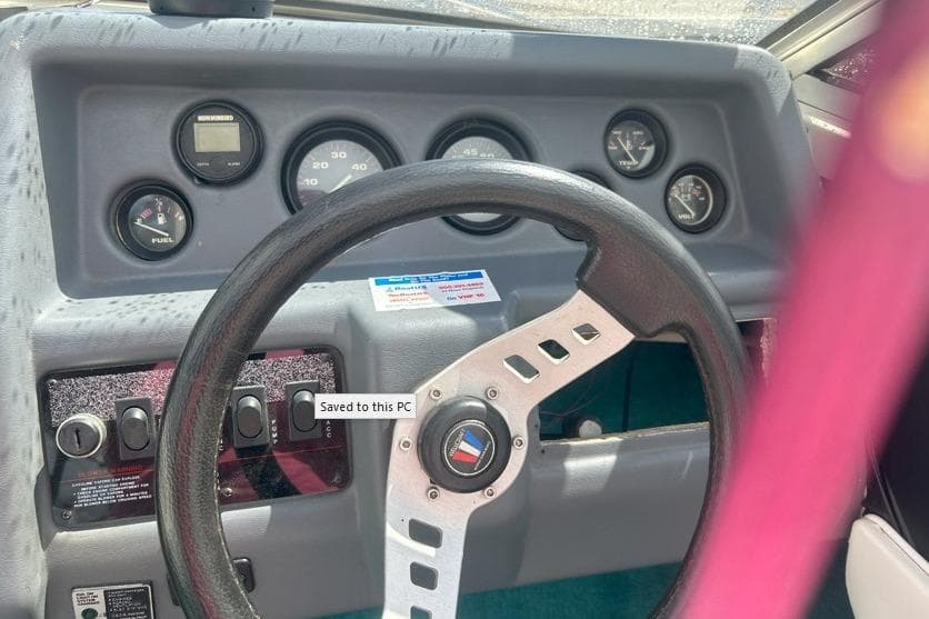 1991 Wellcraft 216 Eclipse dashboard with steering wheel and instrument gauges.