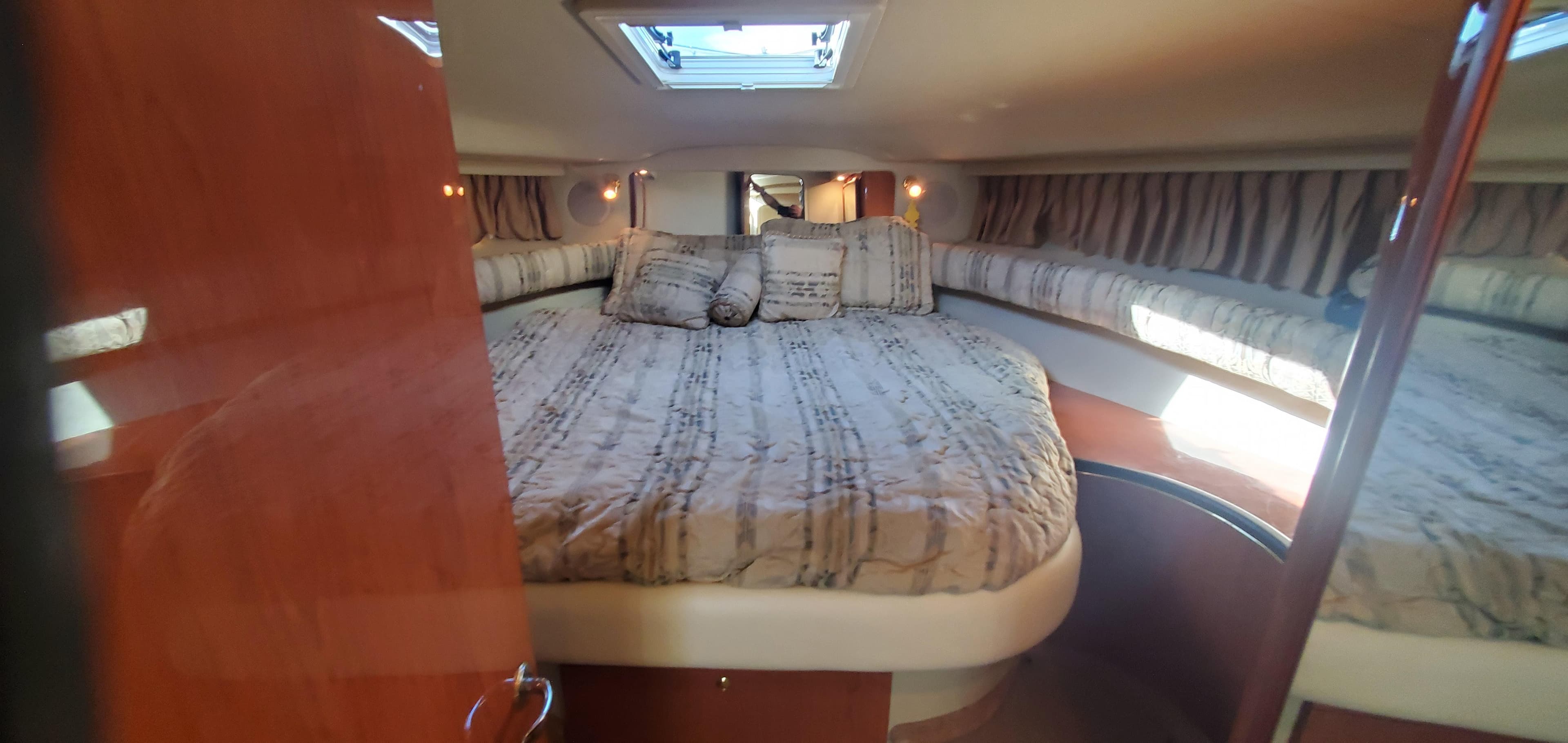 Interior cabin of a 1998 Sea Ray 400 Sundancer yacht with a cozy bed.