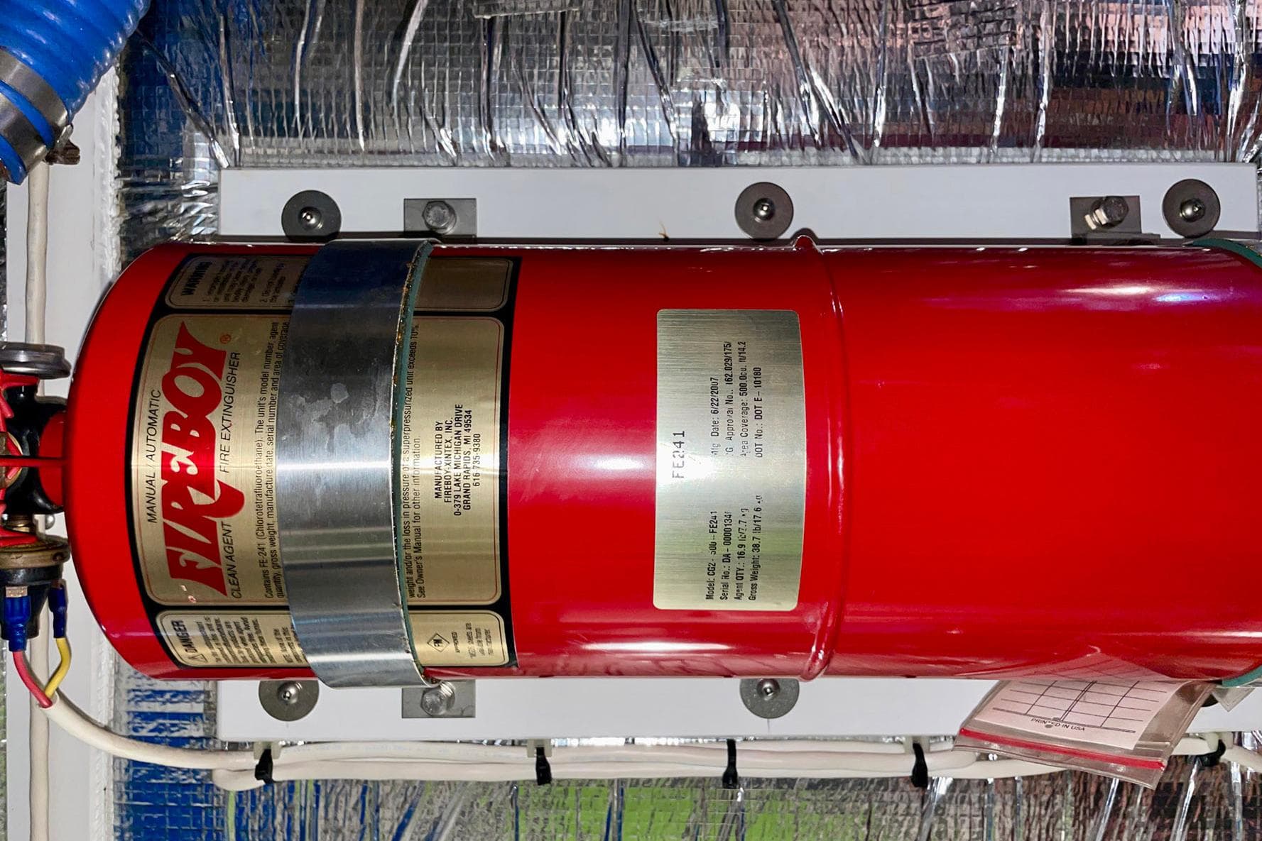 Red Fireboy fire extinguisher installed on a 2008 Nordic Tug 42 boat.