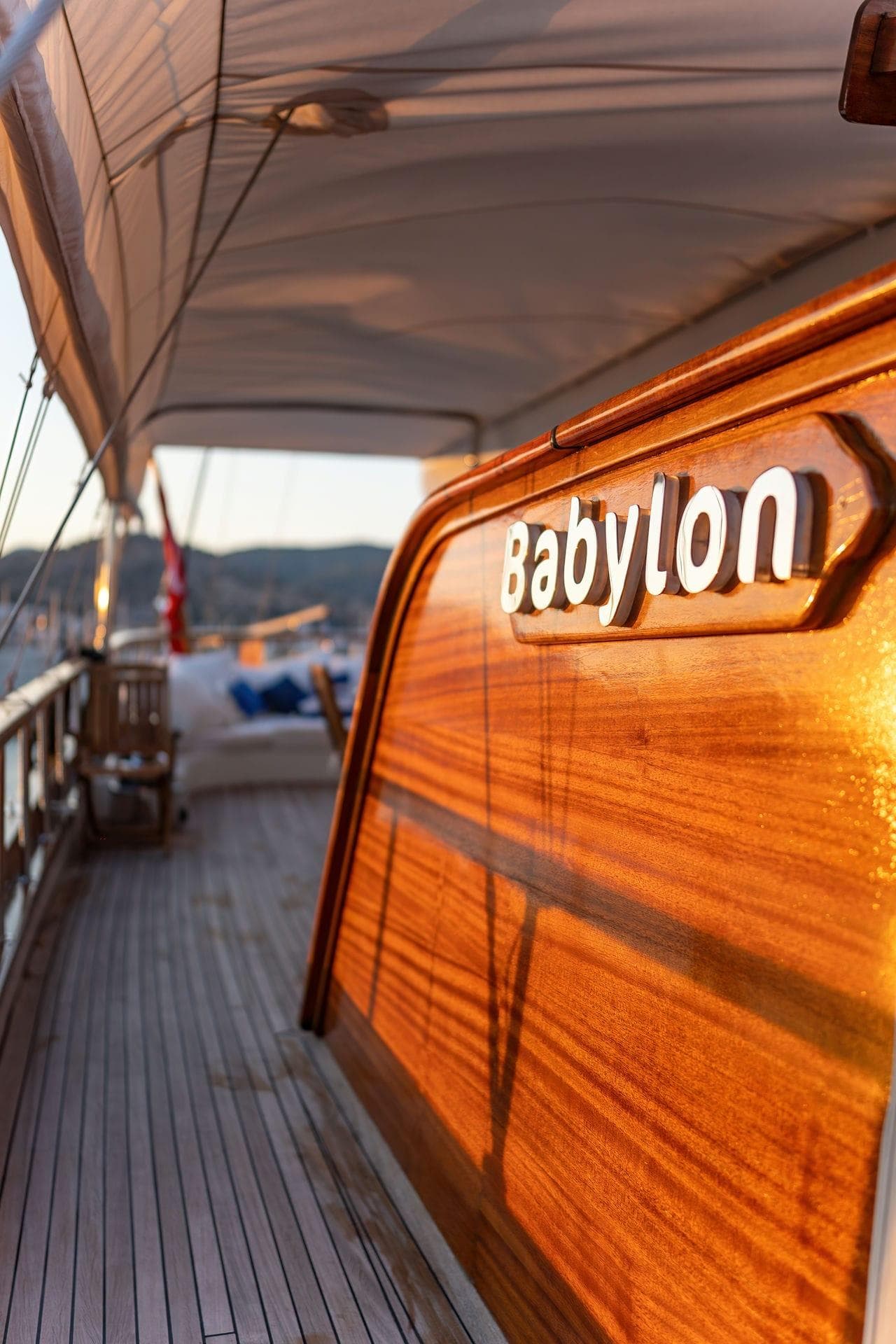Luxurious custom yacht "Babylon" with wooden deck, 2015 model, at sunset.