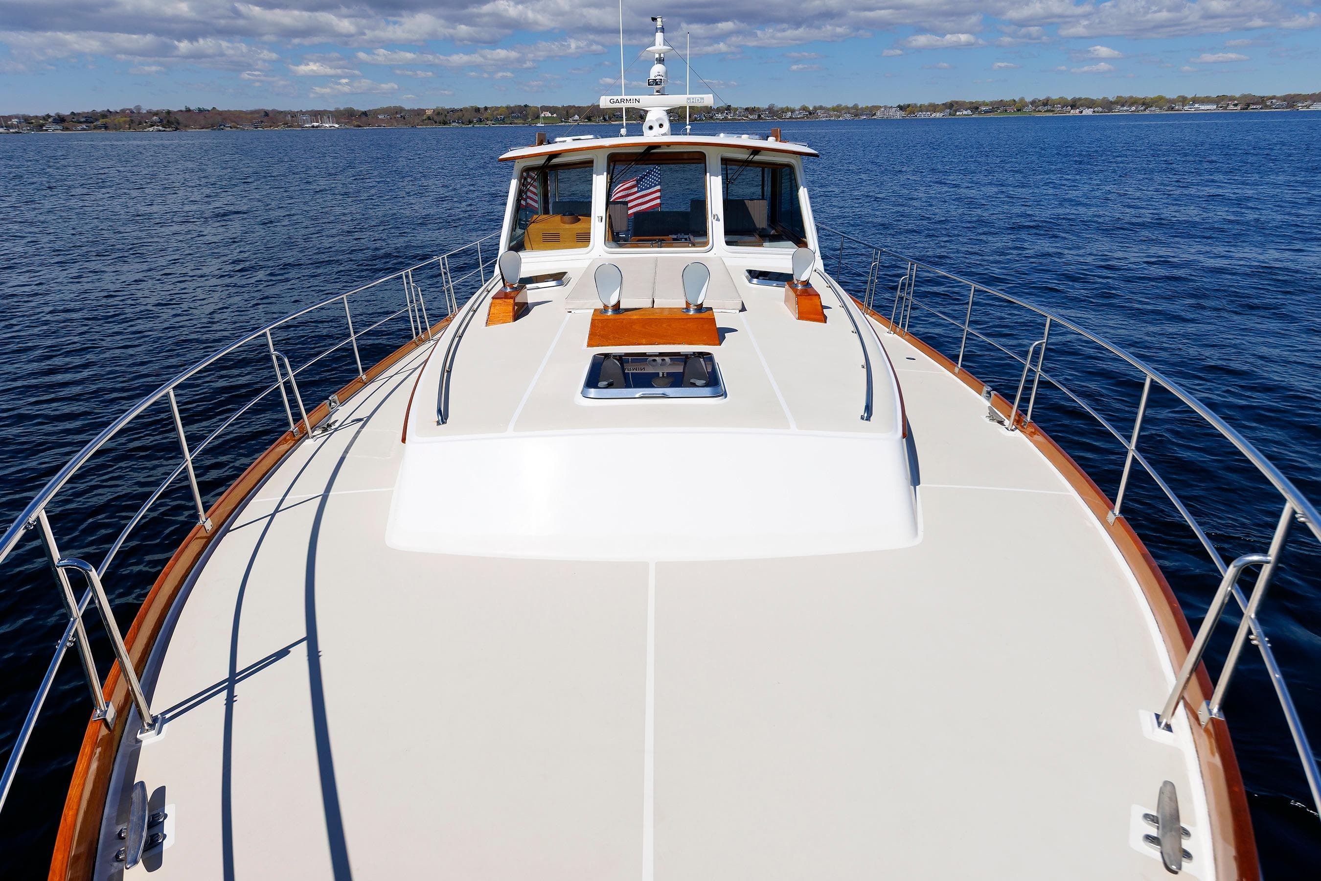 Eastbay 49 yacht from 2000 on calm blue waters under a partly cloudy sky.
