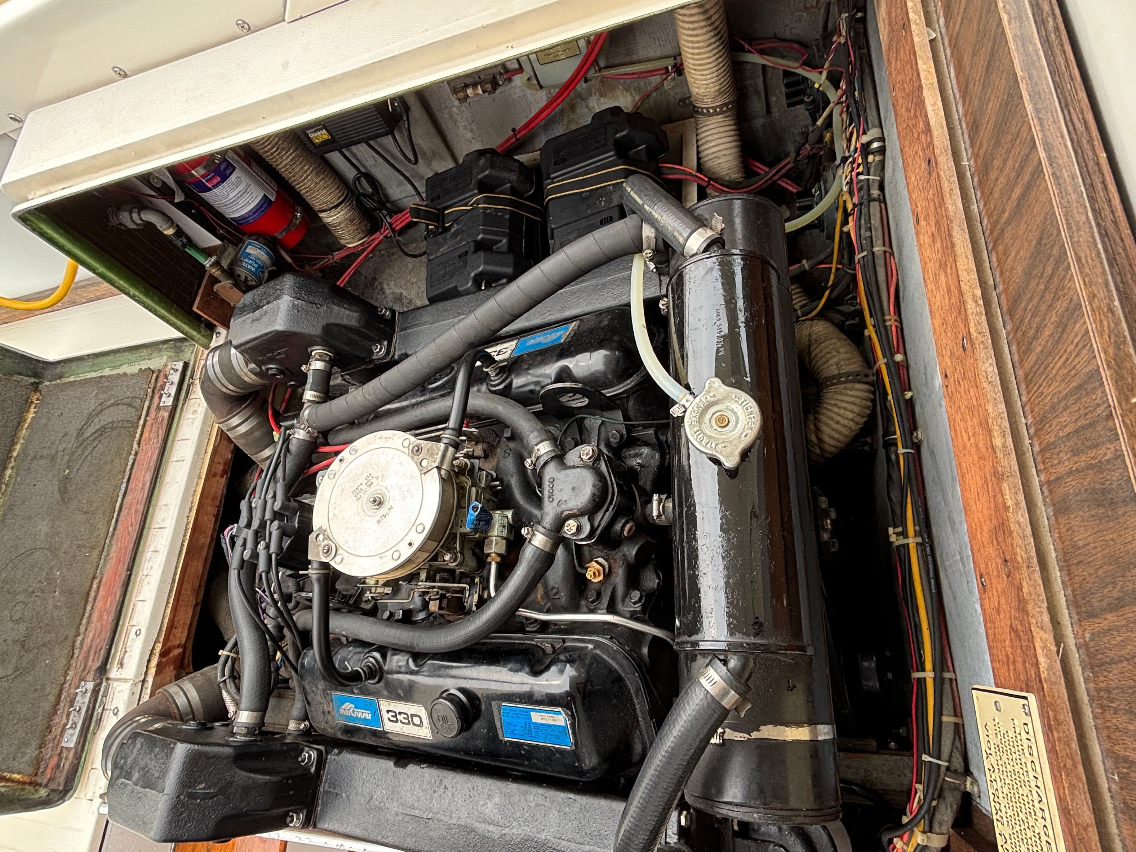 Engine compartment of a 1978 Bertram MOPPIE boat with detailed wiring.