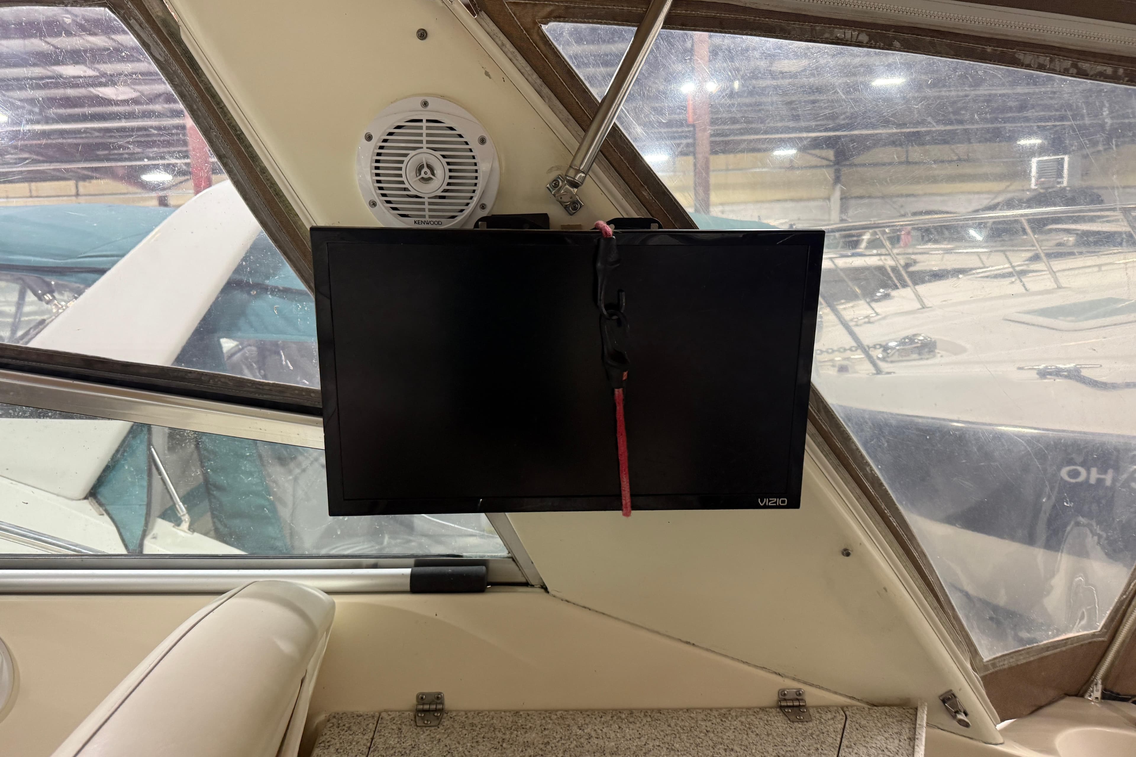 Interior of 2002 Rinker Fiesta Vee 342 with mounted Vizio TV and Kenwood speaker.
