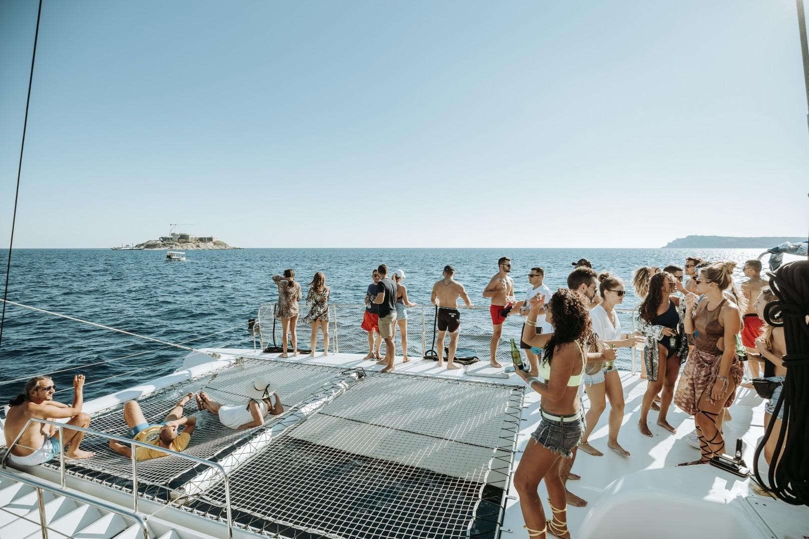 People enjoying a party on a 2015 Fountaine Pajot TAHITI catamaran at sea.
