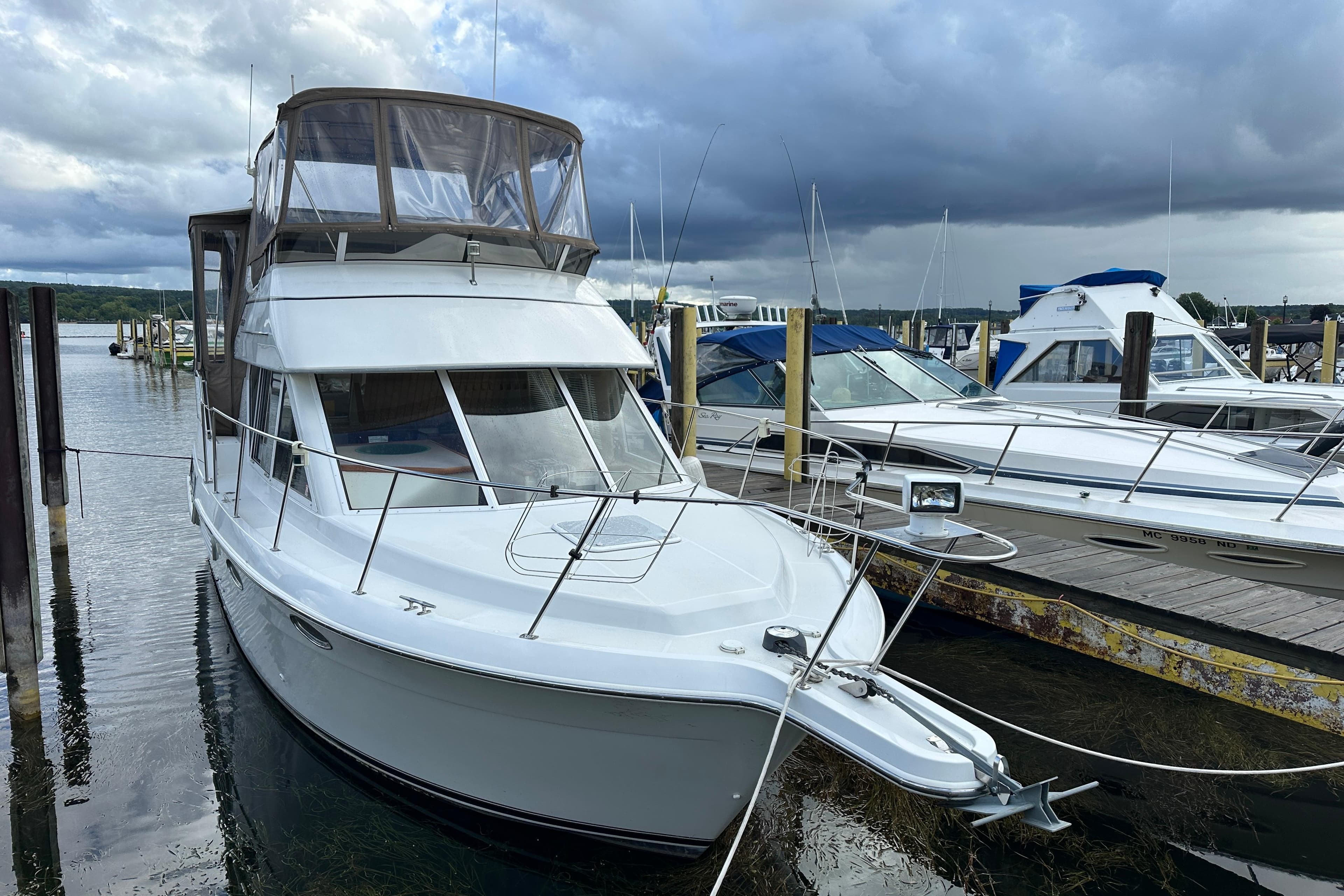 1997 Carver 325 Motor Yacht docked at marina under cloudy skies.