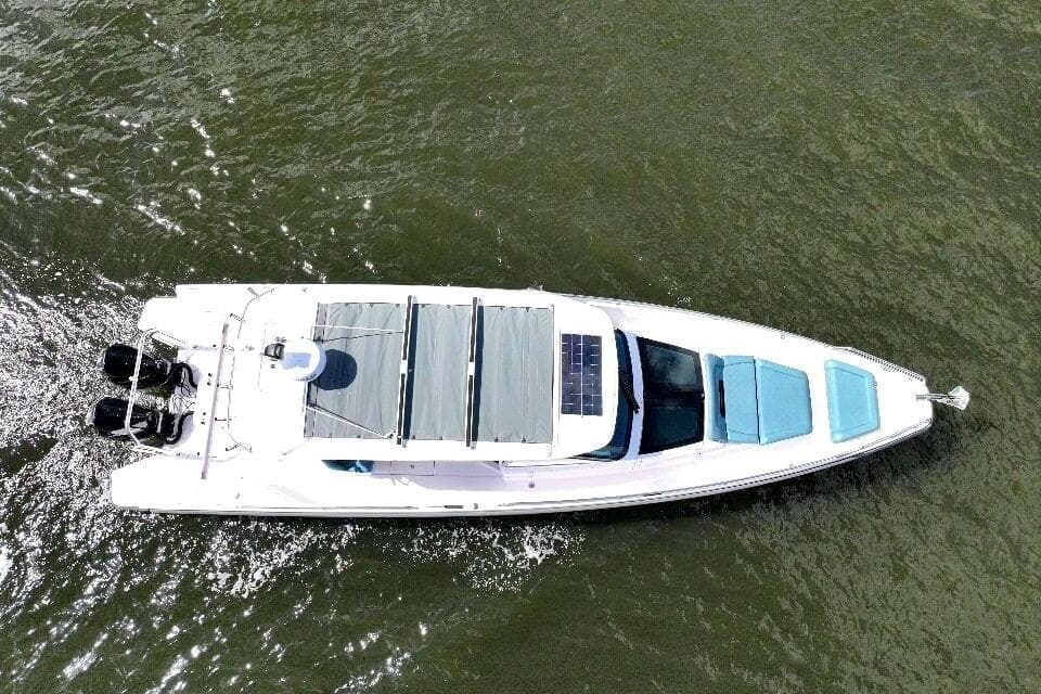 Aerial view of 2022 Axopar 37 Sun-Top boat cruising on water.