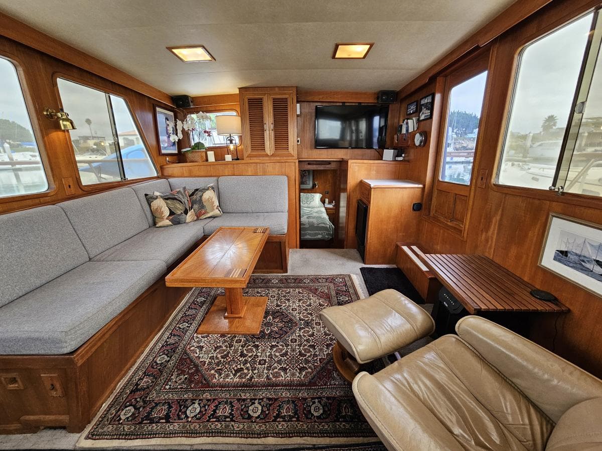 Interior of 1983 Ocean Alexander 43 yacht with cozy seating and elegant wood finishes.