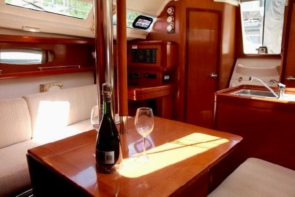 Interior of 2008 Beneteau Oceanis 31 yacht with cozy seating and dining area.