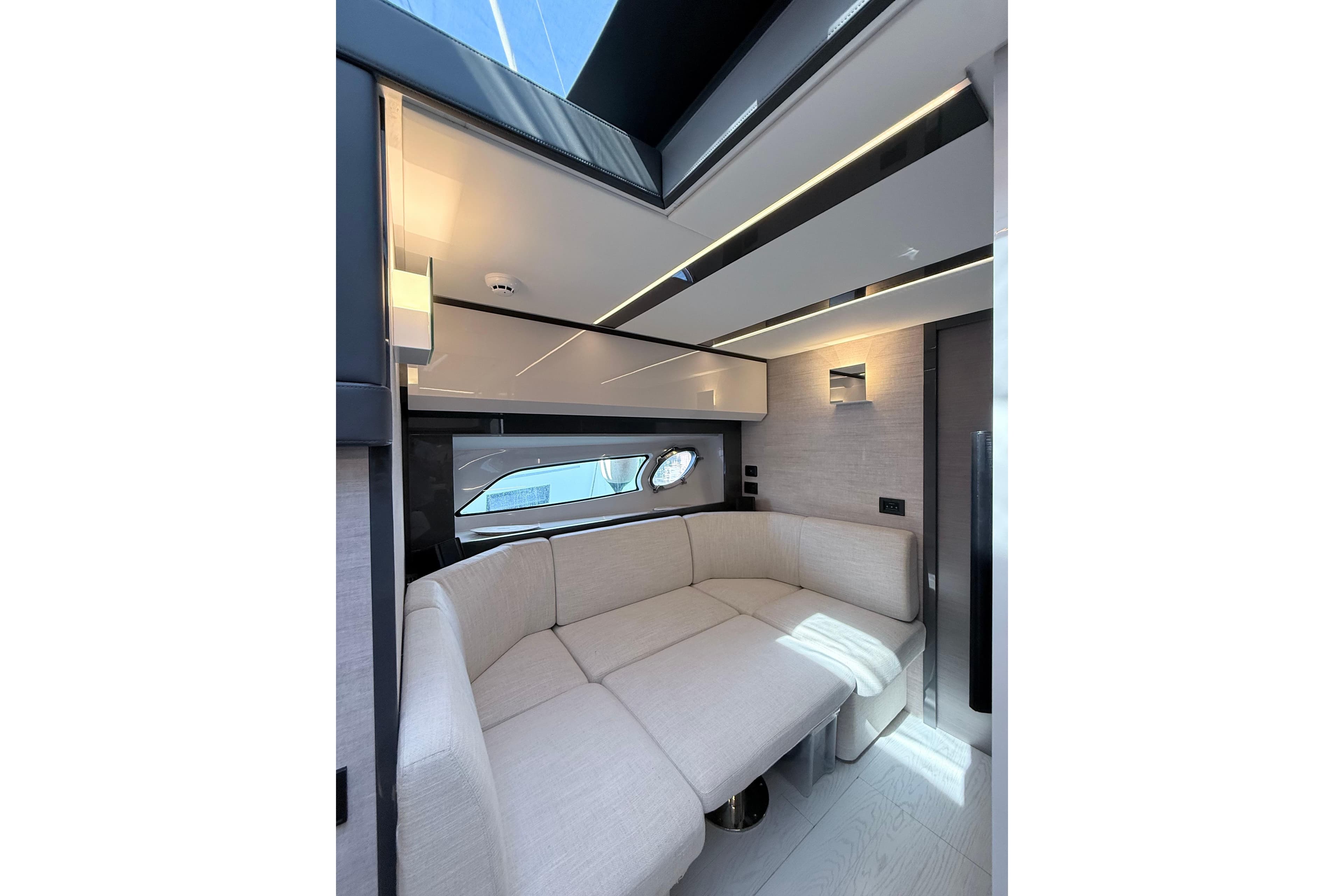 Luxurious interior of 2023 Pershing 5x yacht with modern seating and sleek design.
