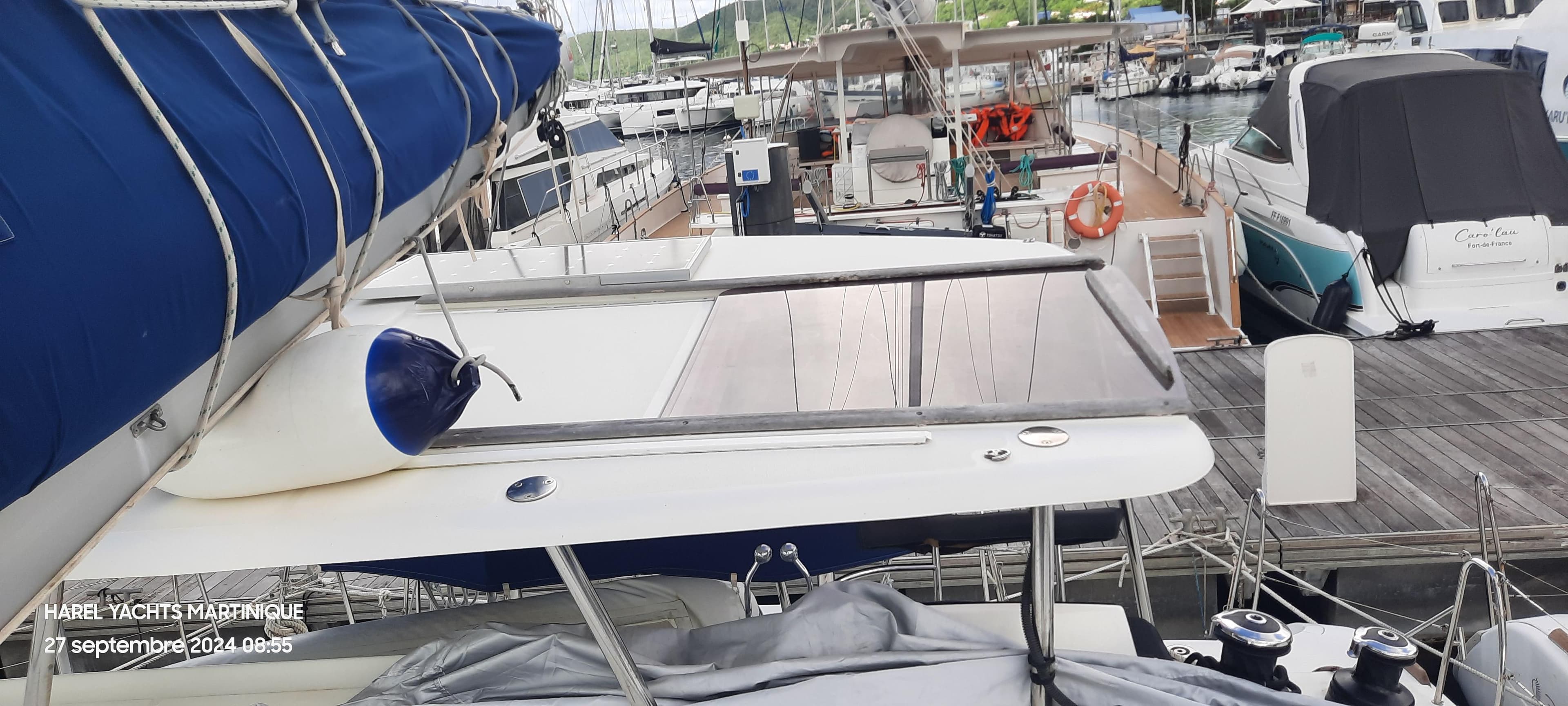 Lagoon 380 catamaran docked at marina, surrounded by other boats, 2018 model.