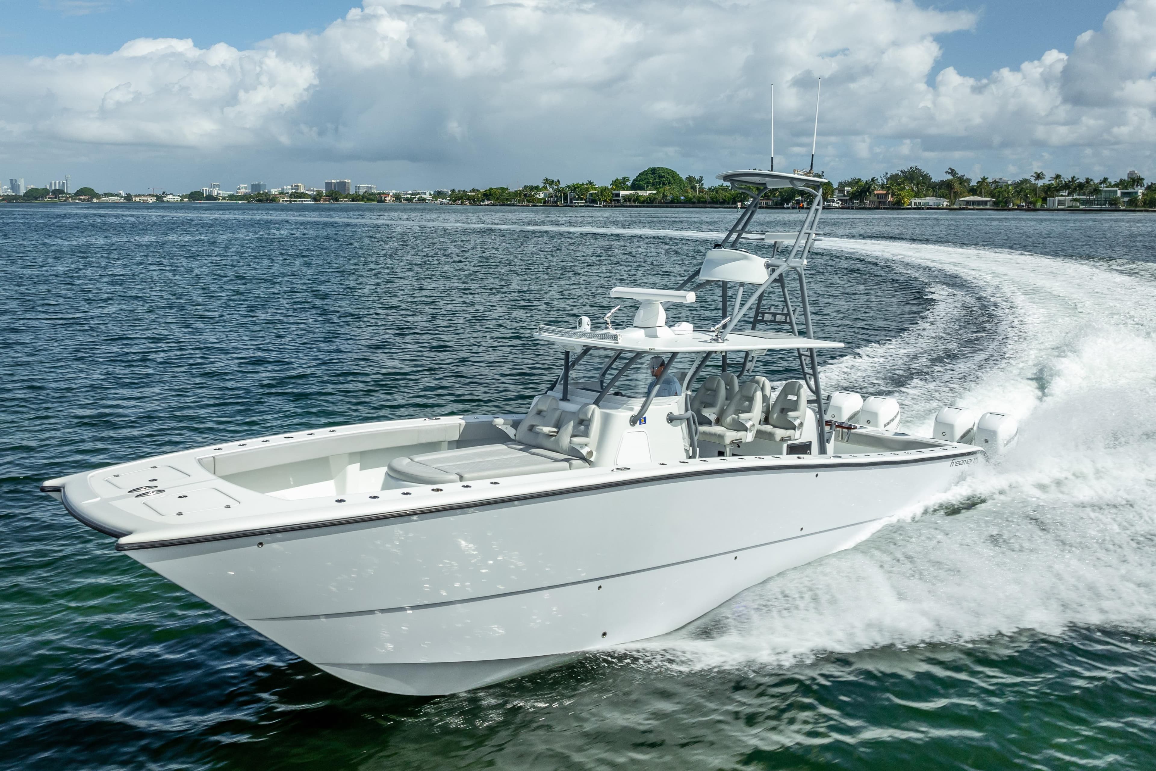 2020 Freeman 42LR boat cruising on open water under a cloudy sky.