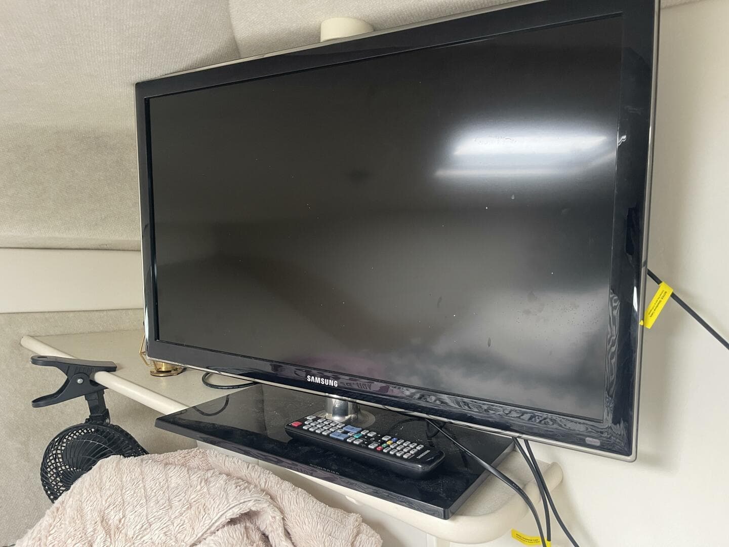 Samsung TV and remote inside a 2001 Bayliner 3258 Ciera Command Bridge boat.