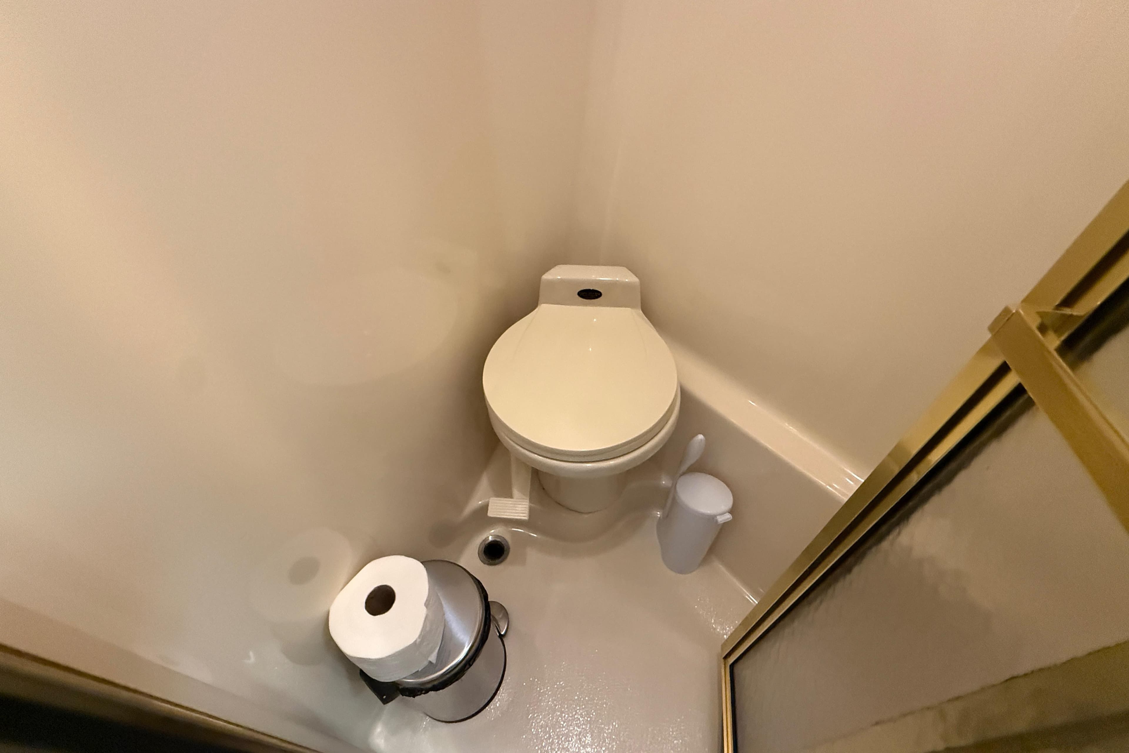 Compact bathroom on 1998 Sea Ray 500 Sundancer yacht, featuring toilet and shower.