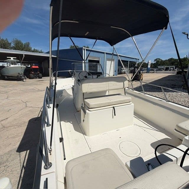 2018 Boston Whaler 170 Montauk boat with canopy outdoors.