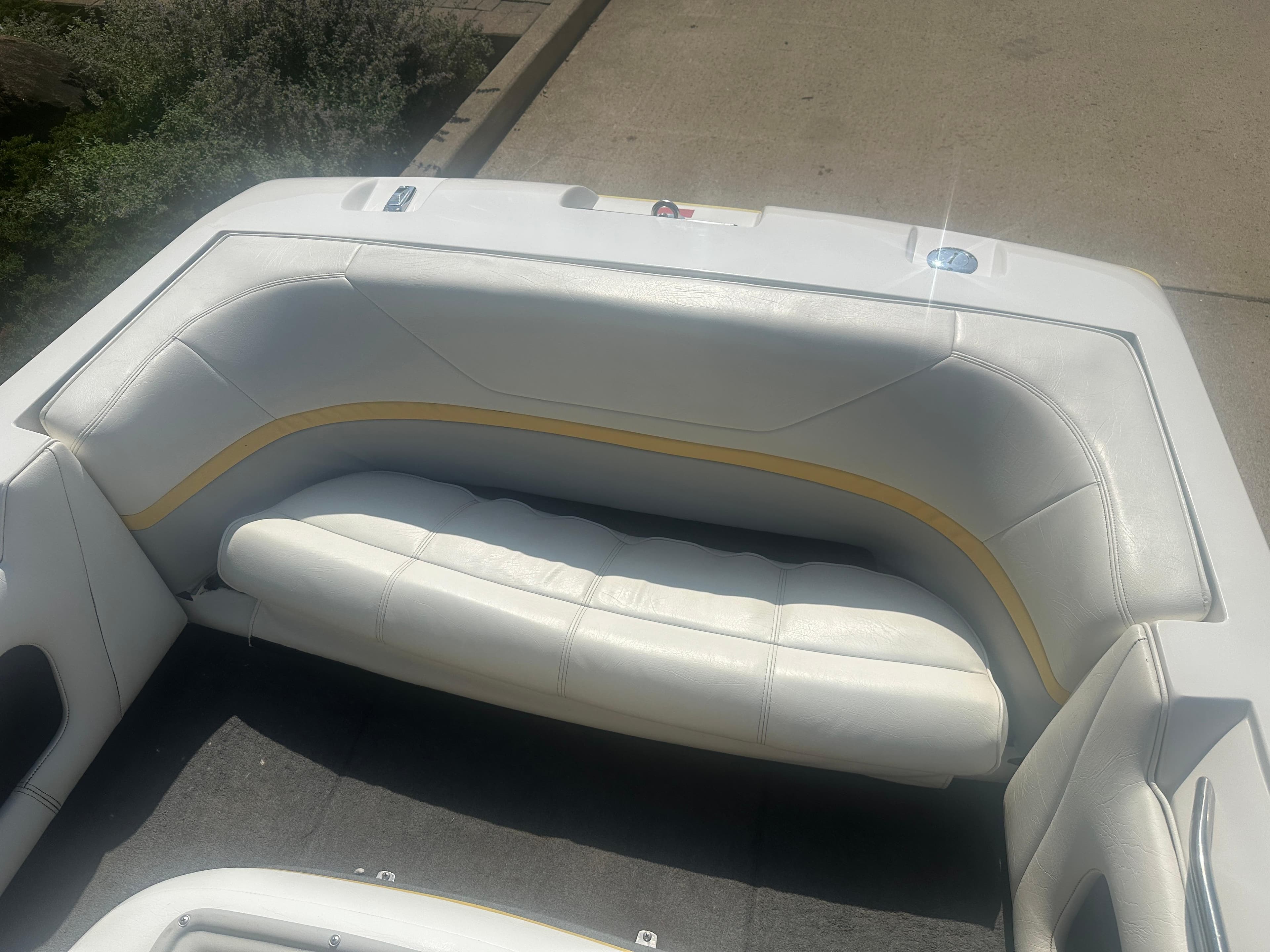 1990 MasterCraft Prostar190 boat interior with white and yellow seating.