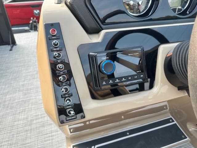 Control panel of 2025 Viaggio Lago X-F boat with switches and audio system.