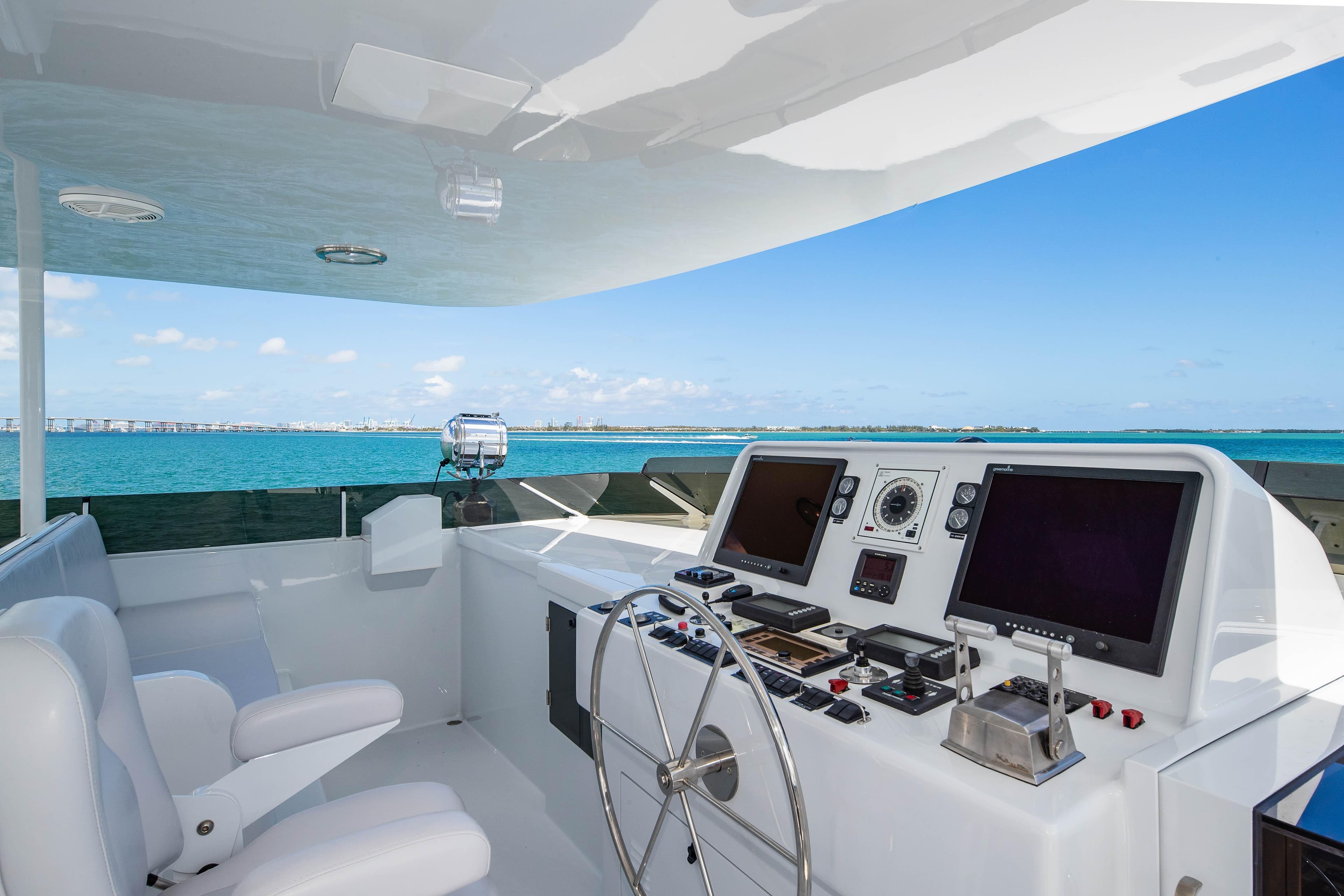 Raised pilothouse of 1998 Burger yacht with ocean view and navigation equipment.