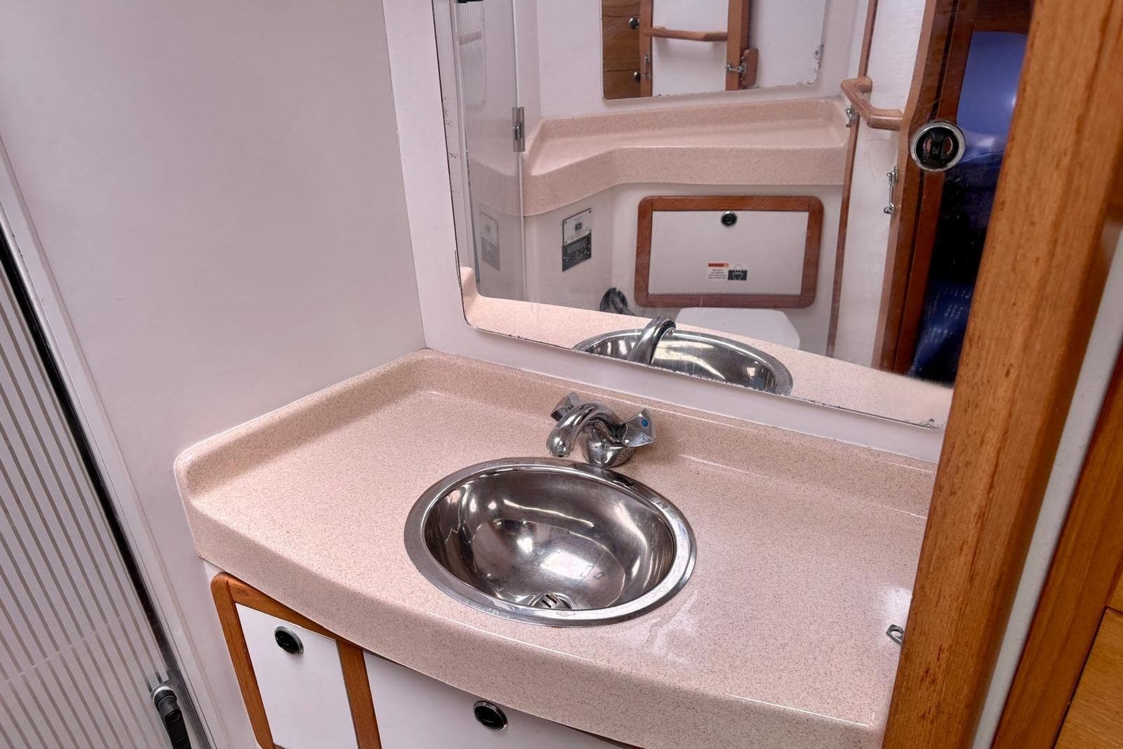 Bathroom sink area in a 2000 Catalina 42 MkII yacht, featuring a mirror and countertop.