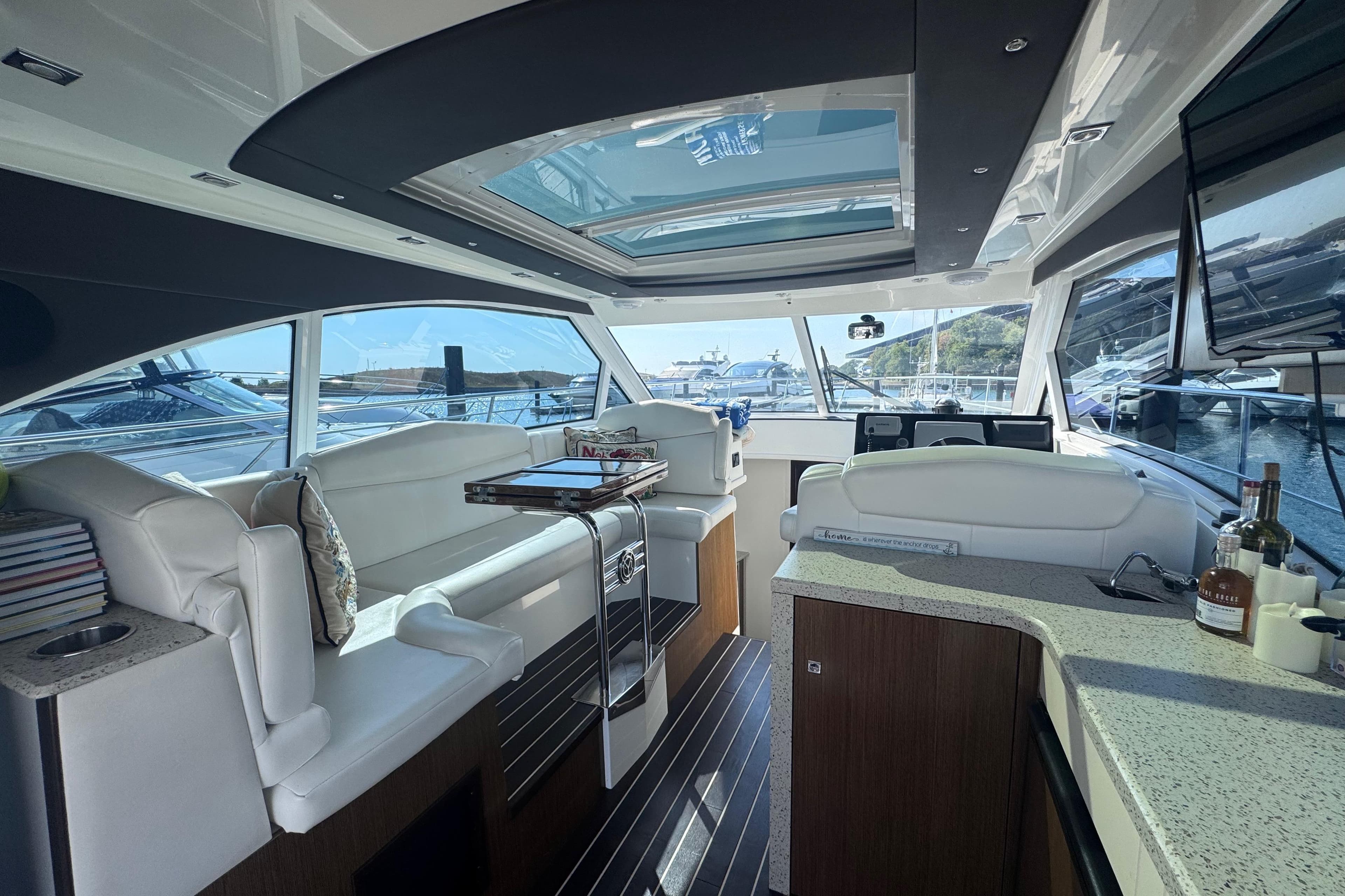 Luxurious interior of 2012 Cruisers Yachts 41 Cantius with elegant seating and panoramic windows.