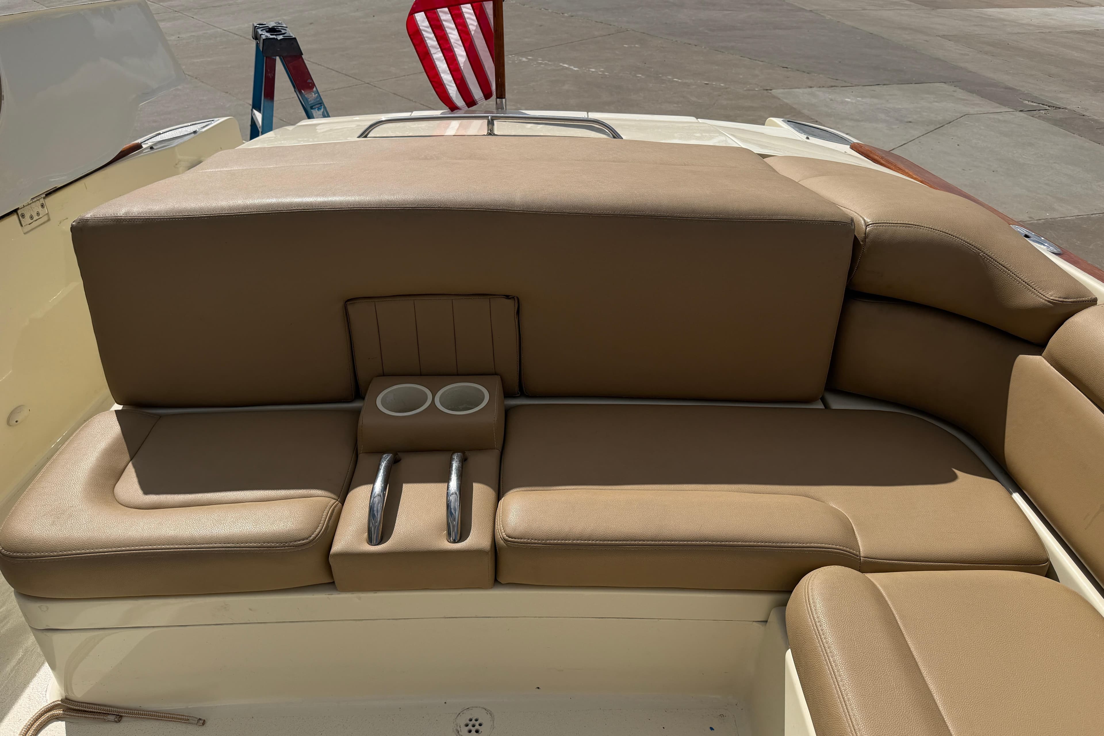 2001 Chris-Craft Launch 28 boat interior with tan leather seating and cup holders.