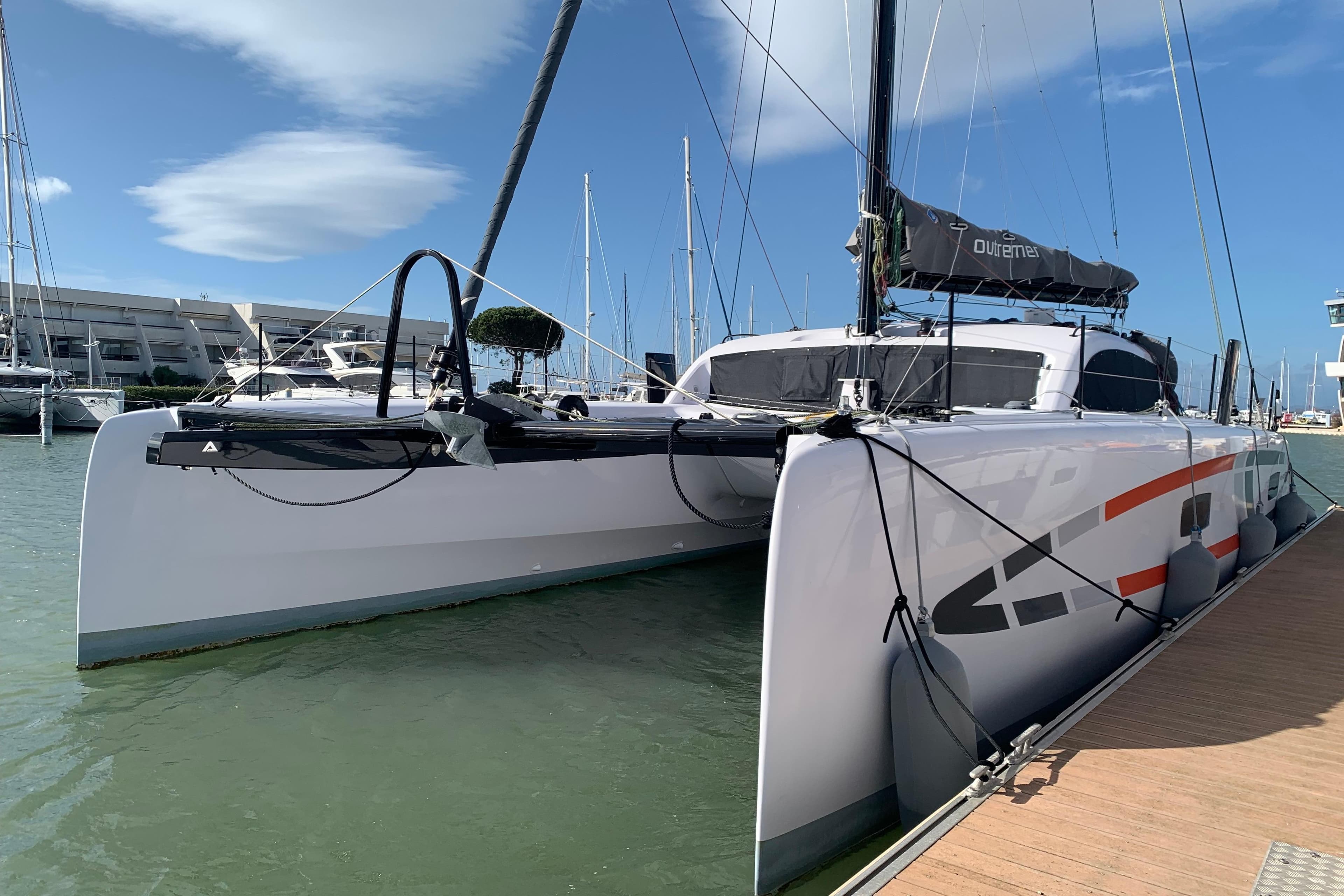 2025 Outremer 4X catamaran docked at marina, showcasing sleek design and modern features.