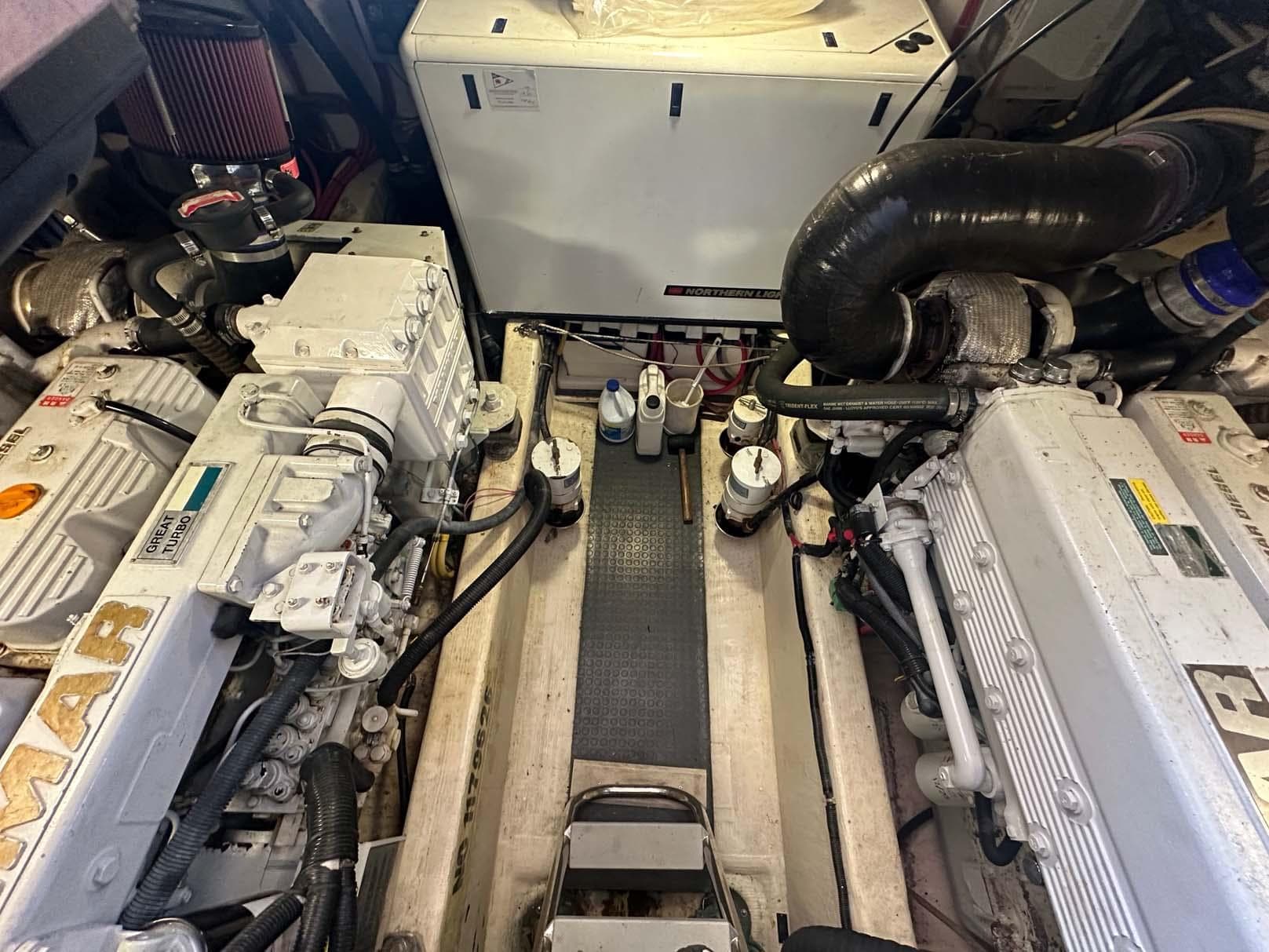 Engine room of a 2005 Sabre 42 Express boat, showcasing dual engines and mechanical components.