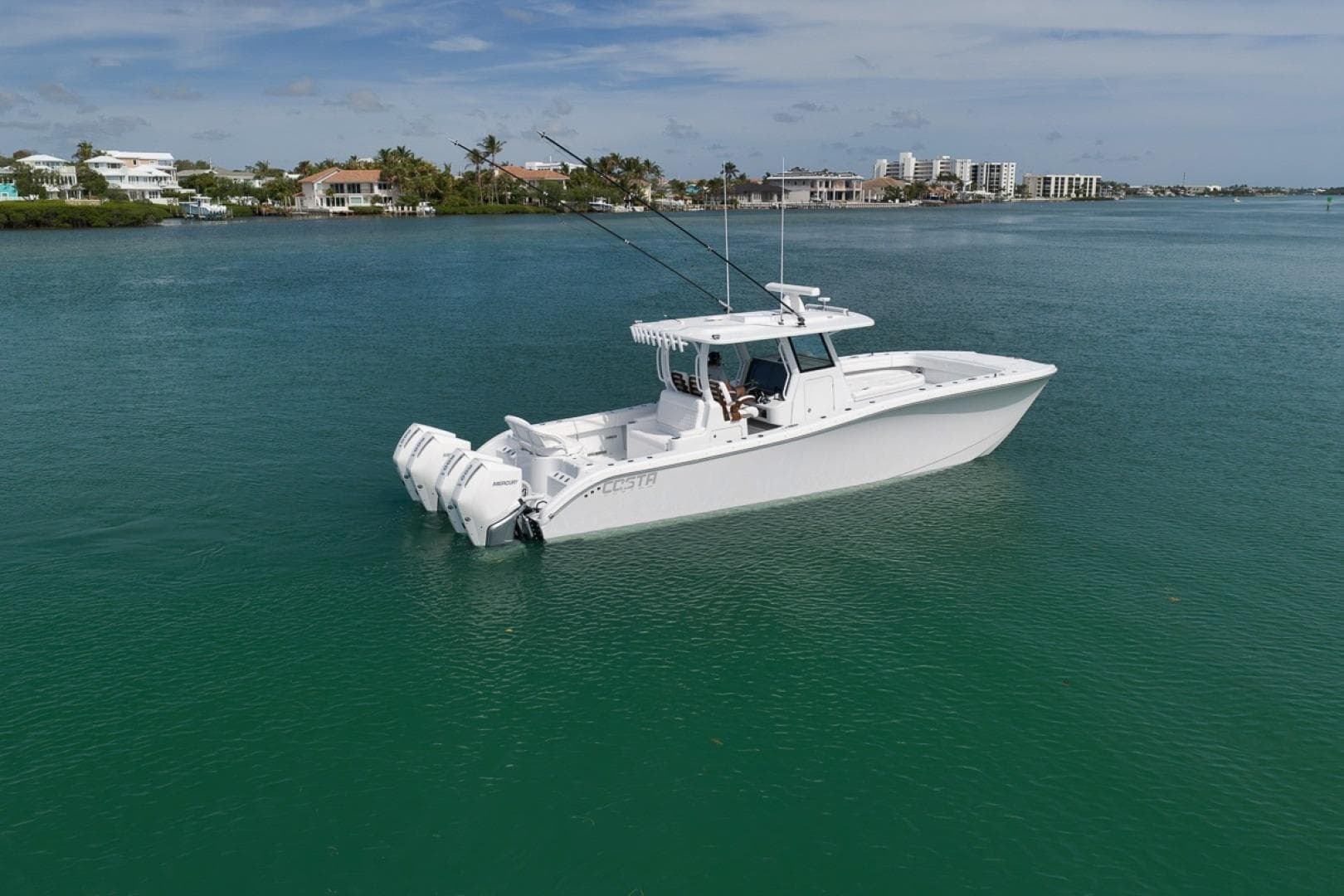 2024 Costa Custom Boats 34SV on calm water, showcasing sleek design and triple engines.
