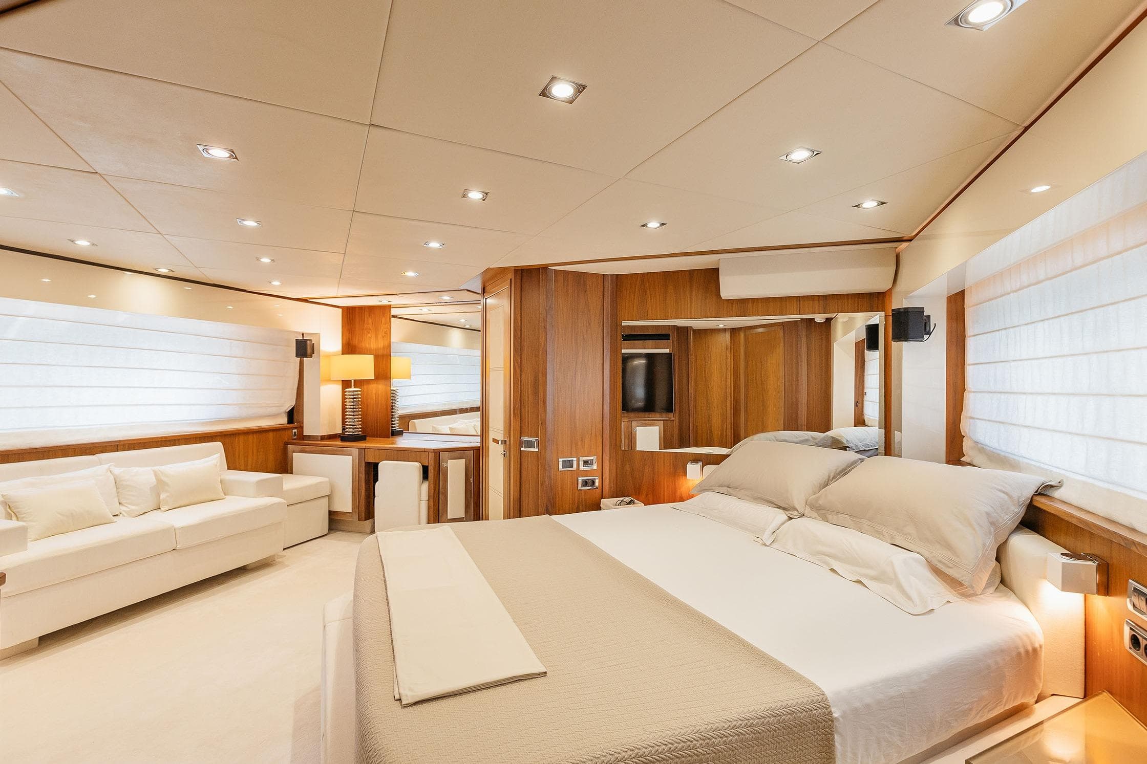 Luxurious bedroom interior of 2009 Sunseeker Predator 92 yacht with modern furnishings.