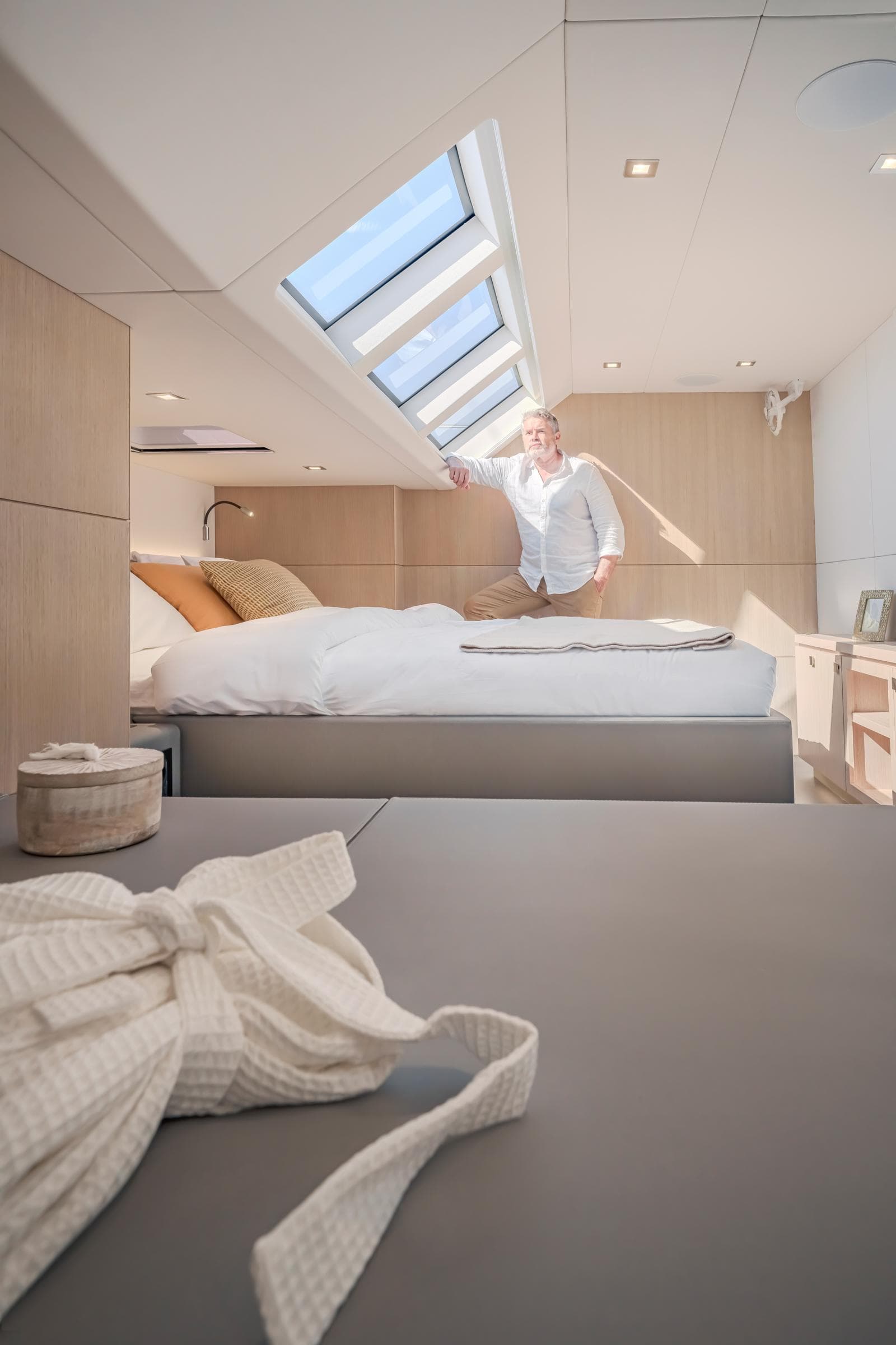 Luxurious bedroom in 2025 Privilege Signature 650 yacht with skylight and modern decor.