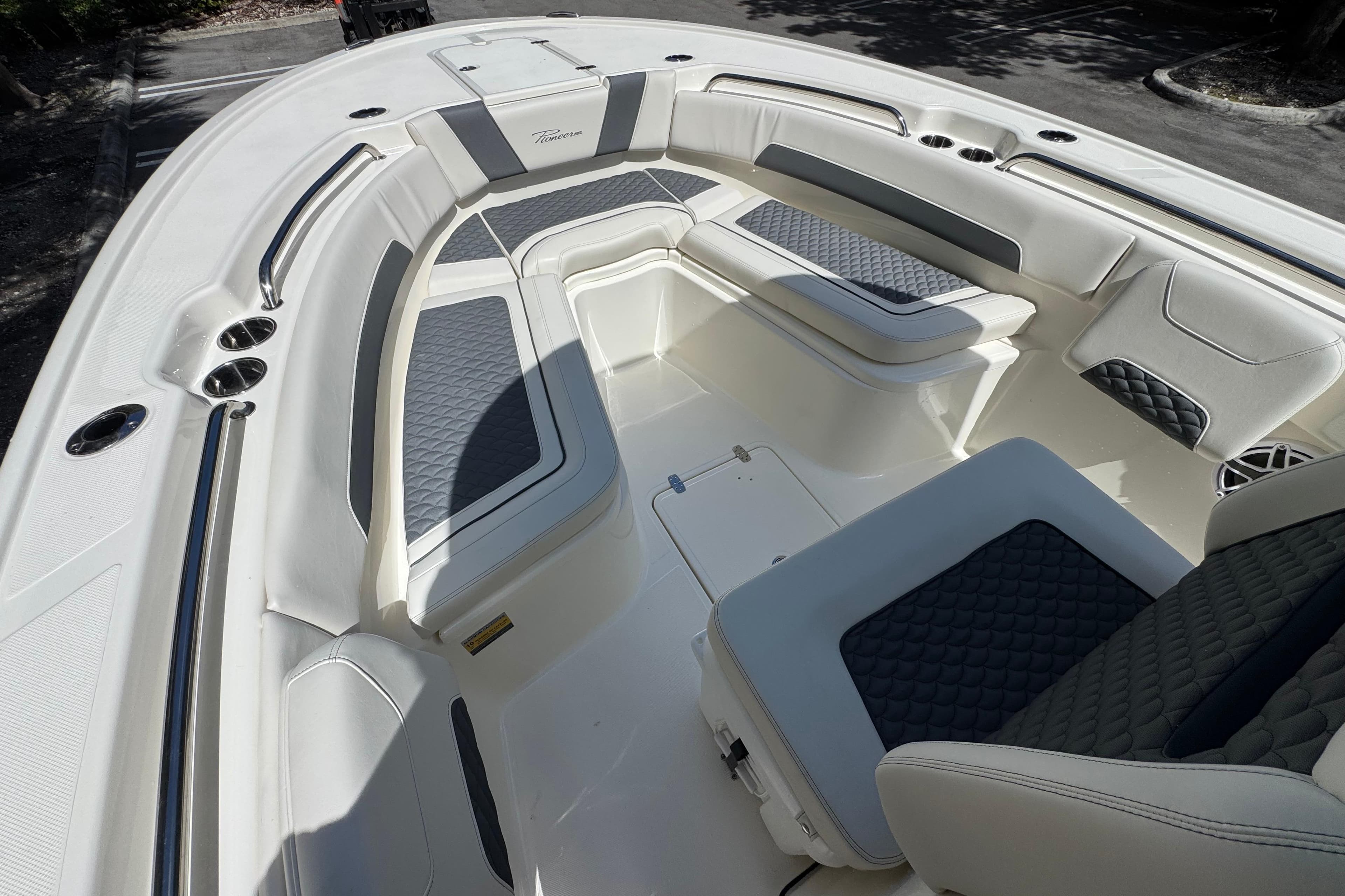 2026 Pioneer 250 Pelagic boat interior with cushioned seating and sleek design.