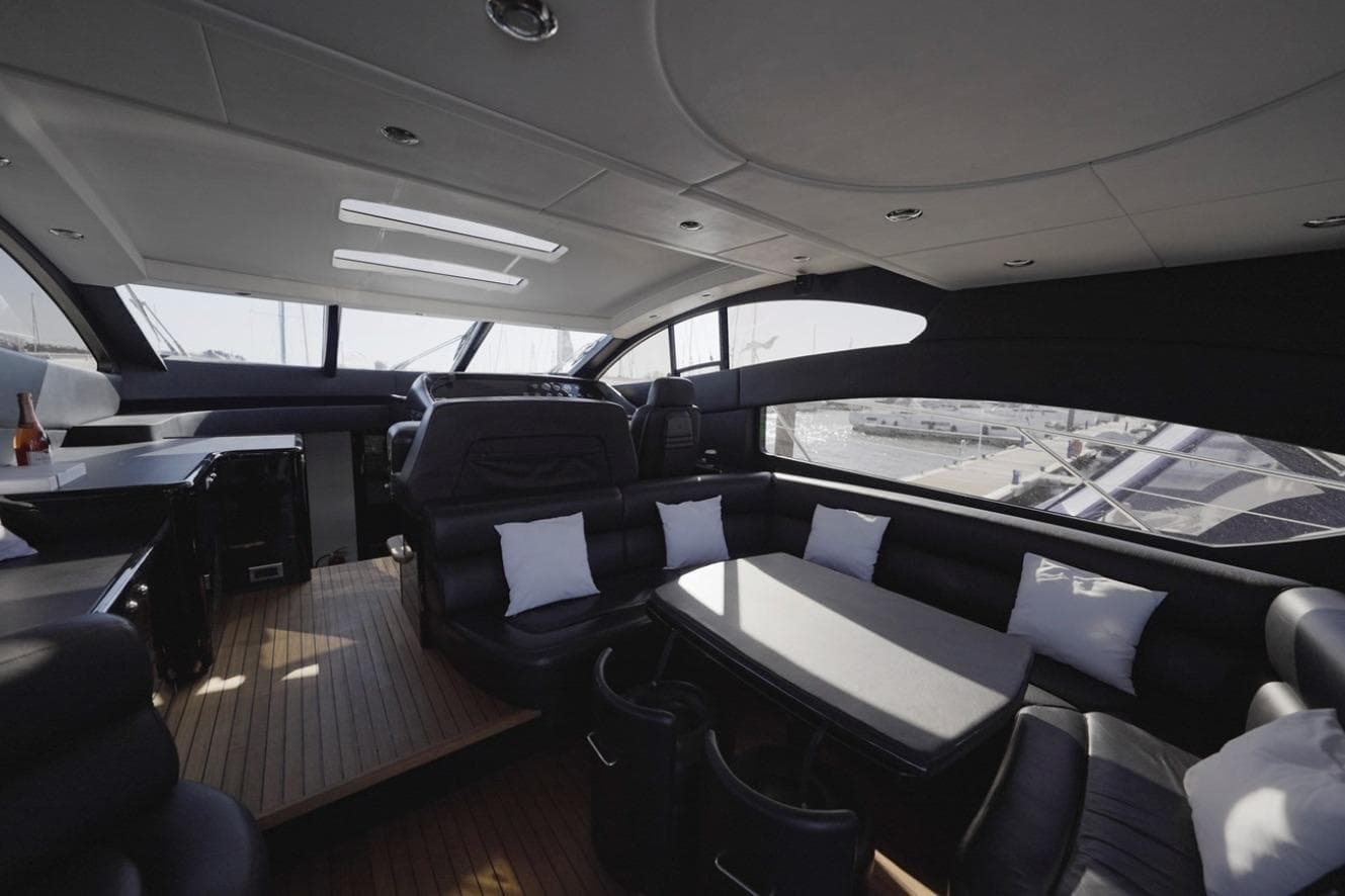 Luxurious interior of 2007 Sunseeker Predator 62 yacht with sleek seating and modern design.