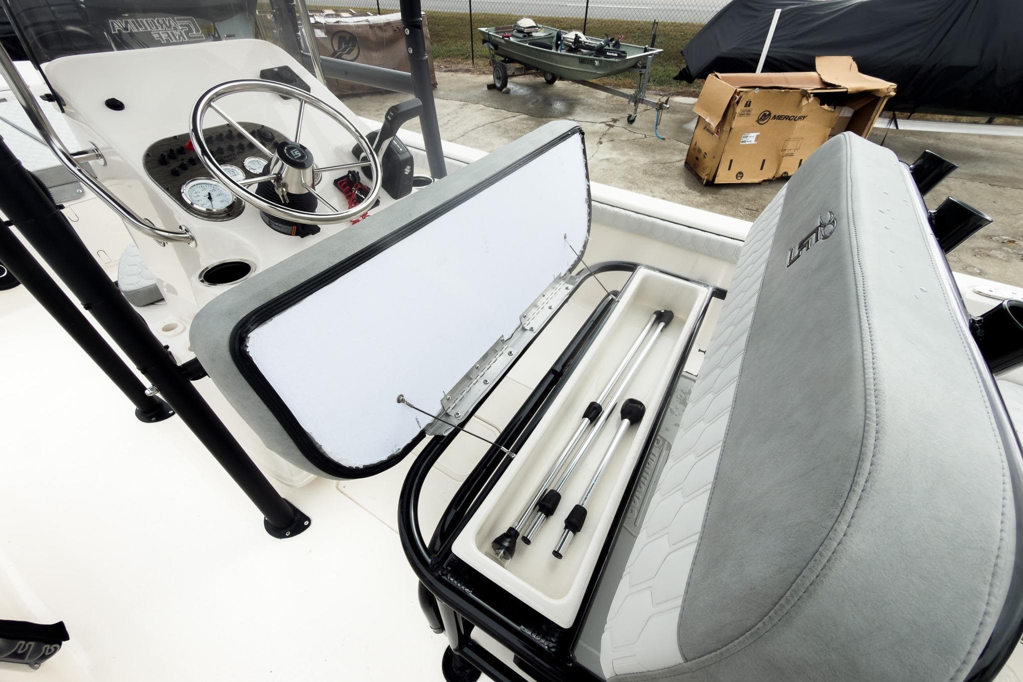 2026 Carolina Skiff 21 LS boat interior with open storage compartment and steering console.
