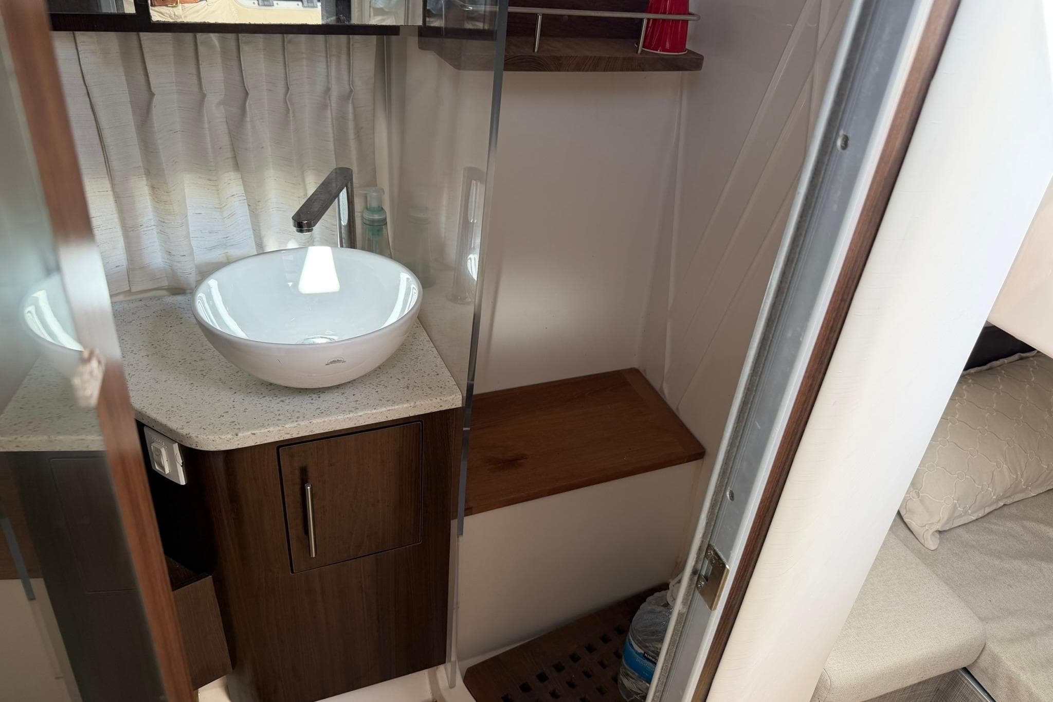 2019 Regal 33 SAV boat interior with modern sink and wooden cabinetry.