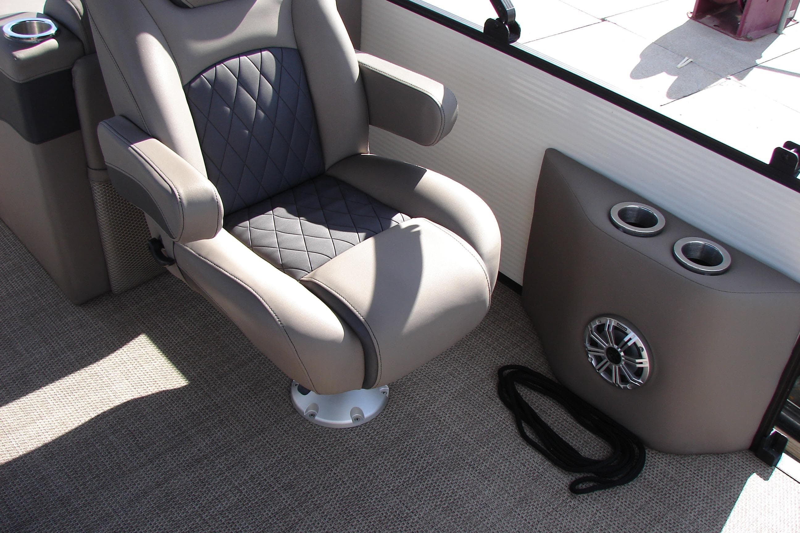 Luxurious seating on 2019 Bennington SX 25 SCWXP boat with cup holders and speaker.