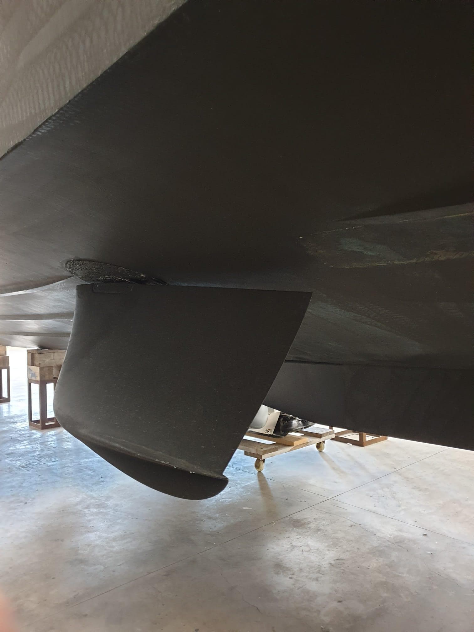 Bottom view of 2021 Greenline OceanClass 68 yacht hull in a workshop.