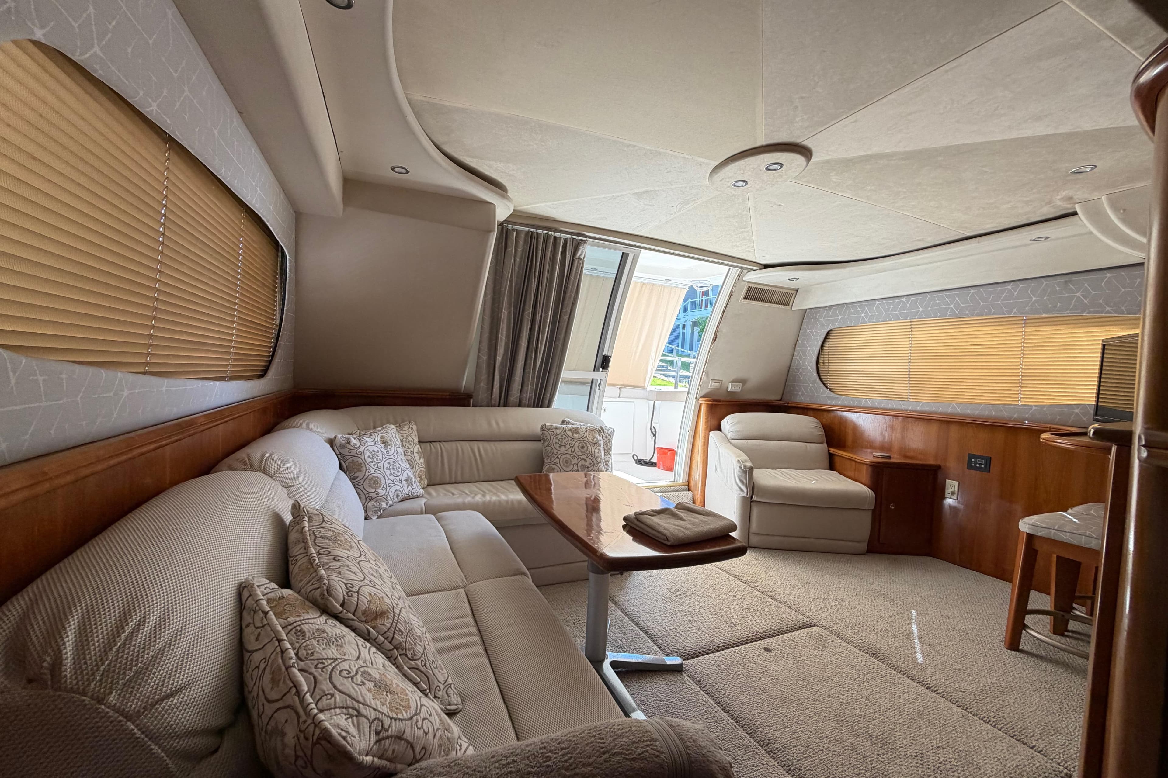 Luxurious interior of a 2001 Silverton 410 Sport Bridge yacht with plush seating and elegant decor.