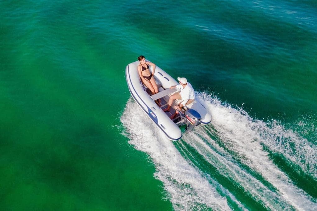 2025 AB Inflatables Lammina 9.5 AL cruising on clear turquoise water.