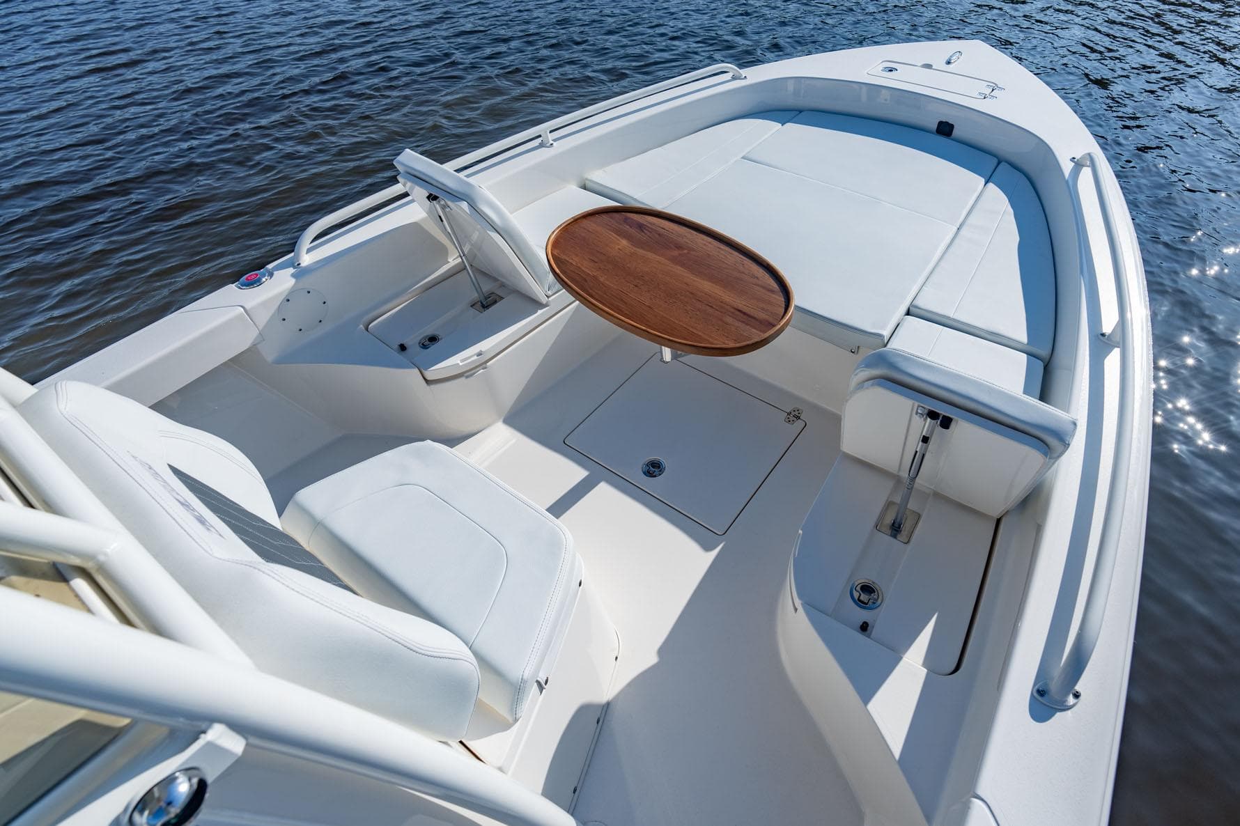 Manufacturer Provided Image: 2026 Pathfinder 2600 TRS boat interior with seating and wooden table on calm water.