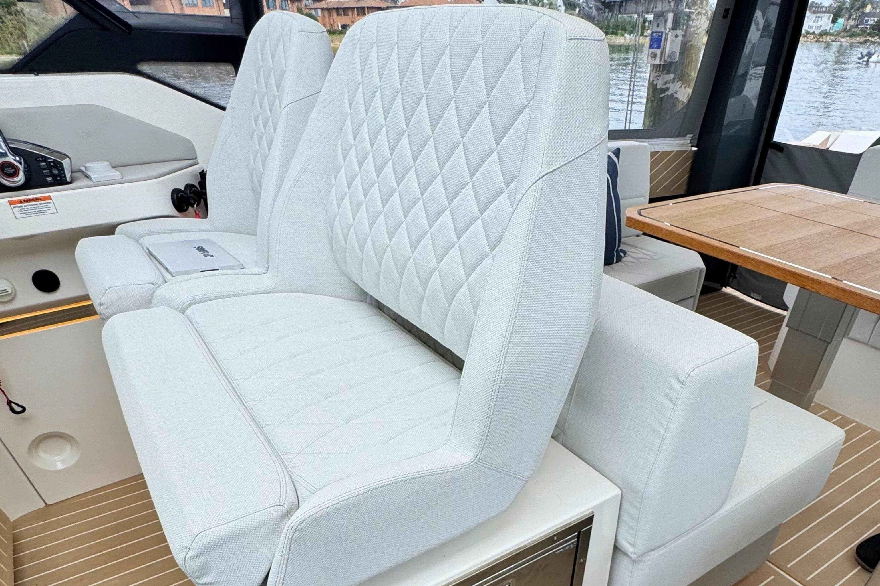 2025 Saxdor 400 GTO interior with plush, diamond-stitched seating and elegant wooden table.